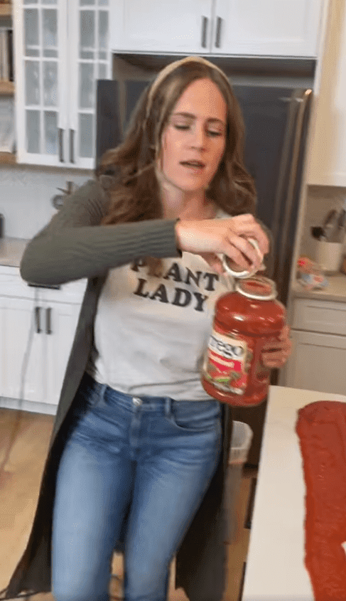 Lisa abriendo el segundo frasco de salsa de tomate para la espaguetada. | Foto: captura video Facebook/Josh and Lisa.