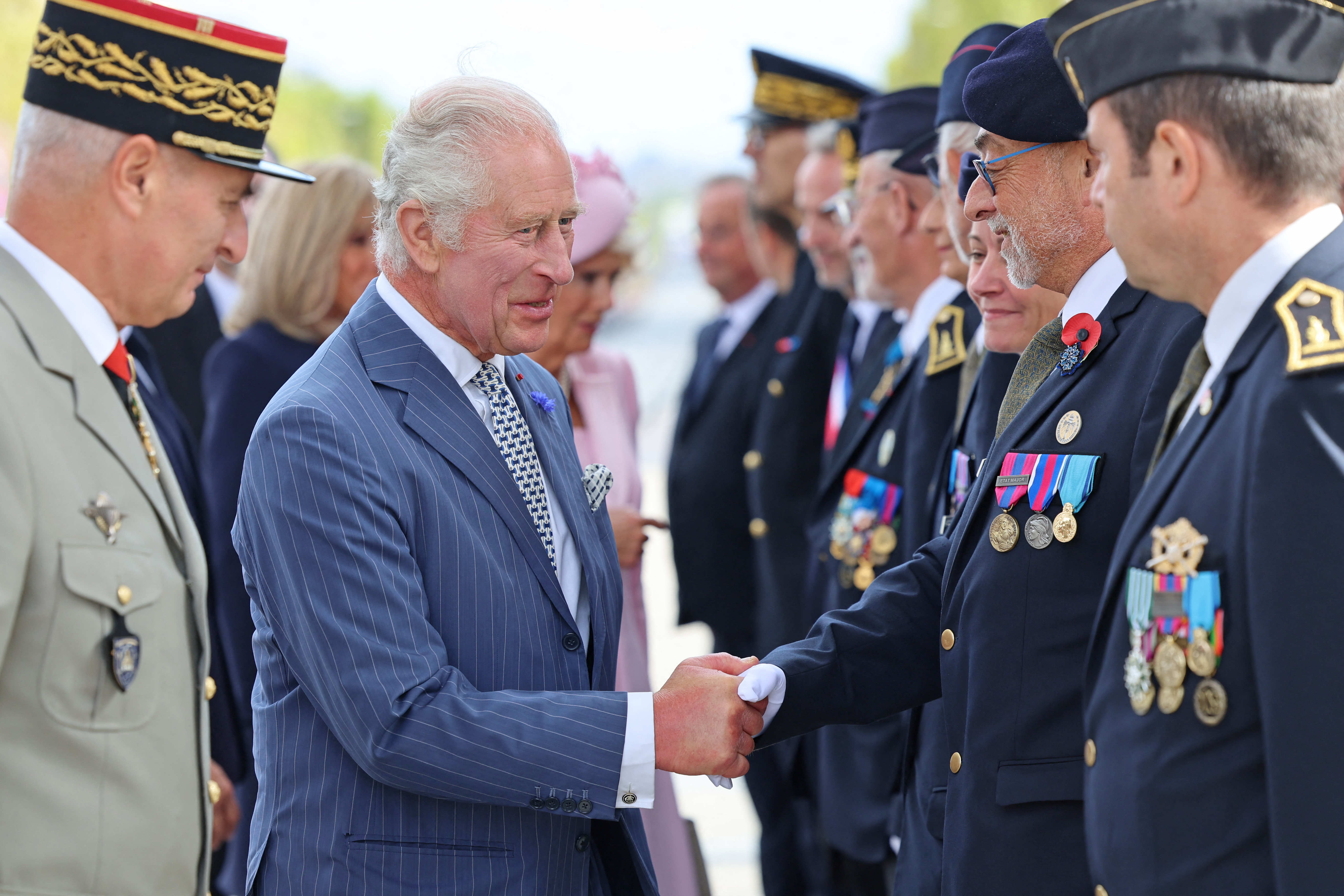 King Charles III shakes hands with members of veterans associations during an official welcoming ceremony at the Arc de Triomphe in Paris on September 20, 2023, on the first day of a state visit to France | Source: Getty Images