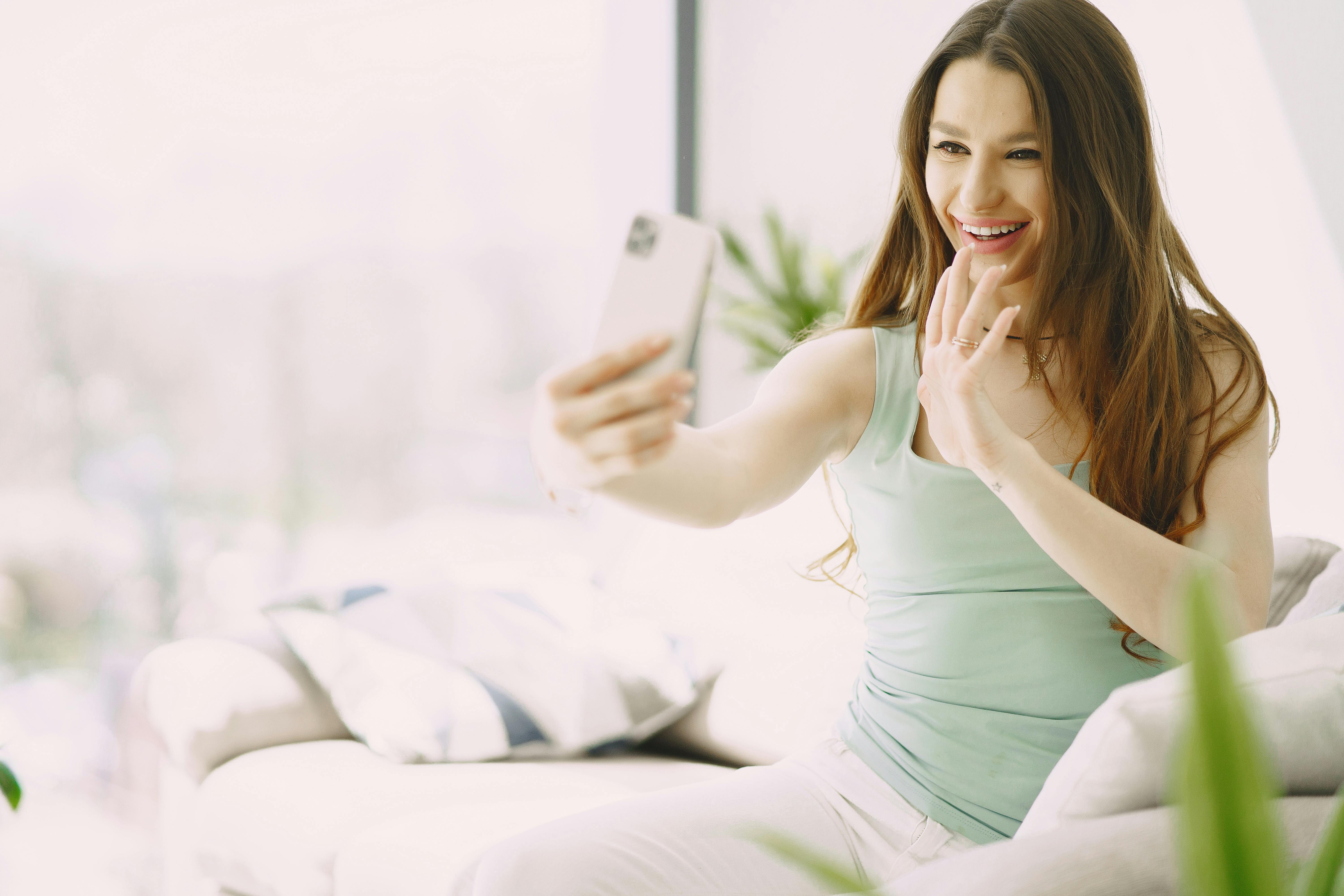 A cheerful woman on video call | Source: Pexels