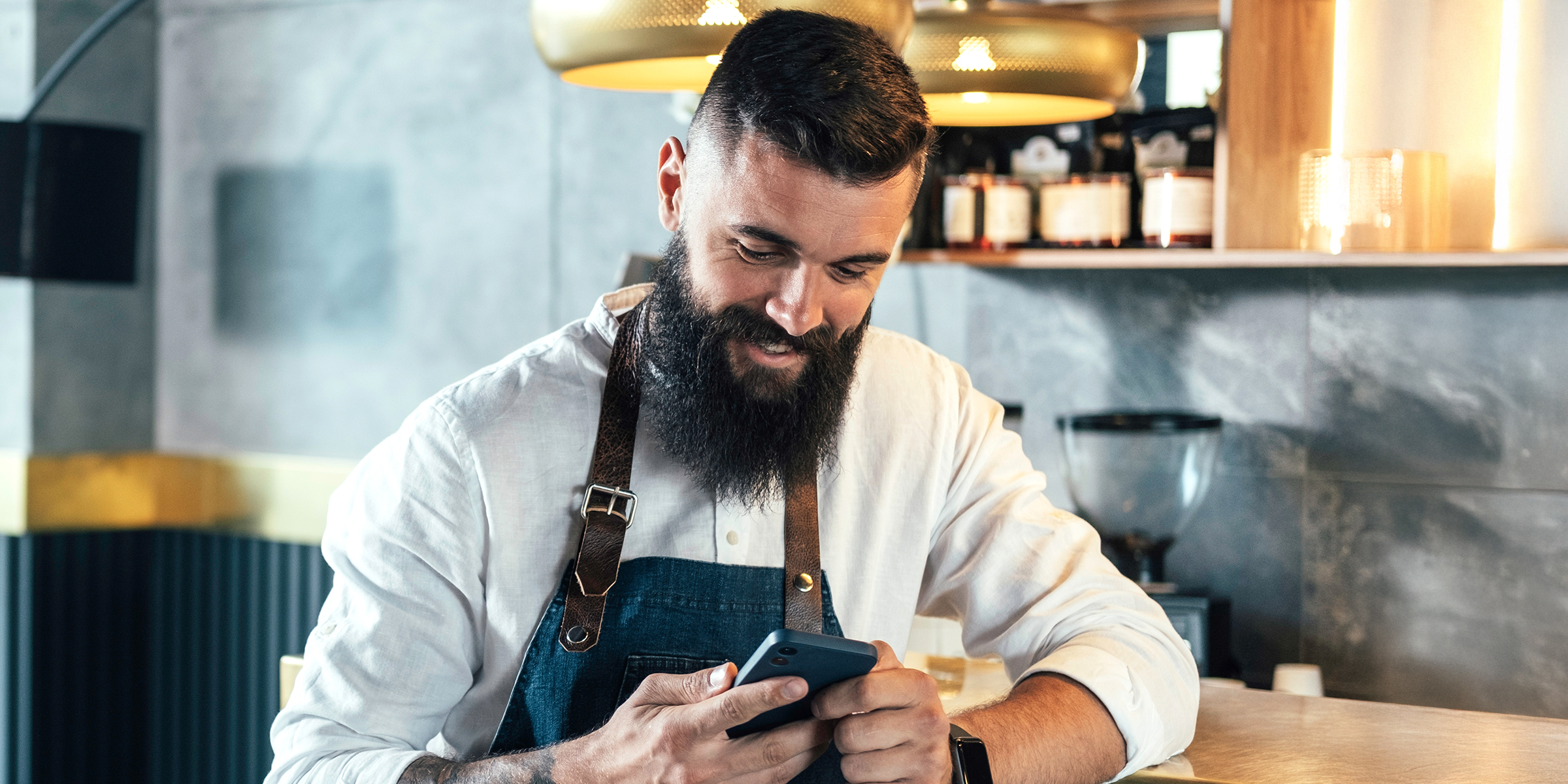 A man looking at his phone and laughing | Source: Shutterstock