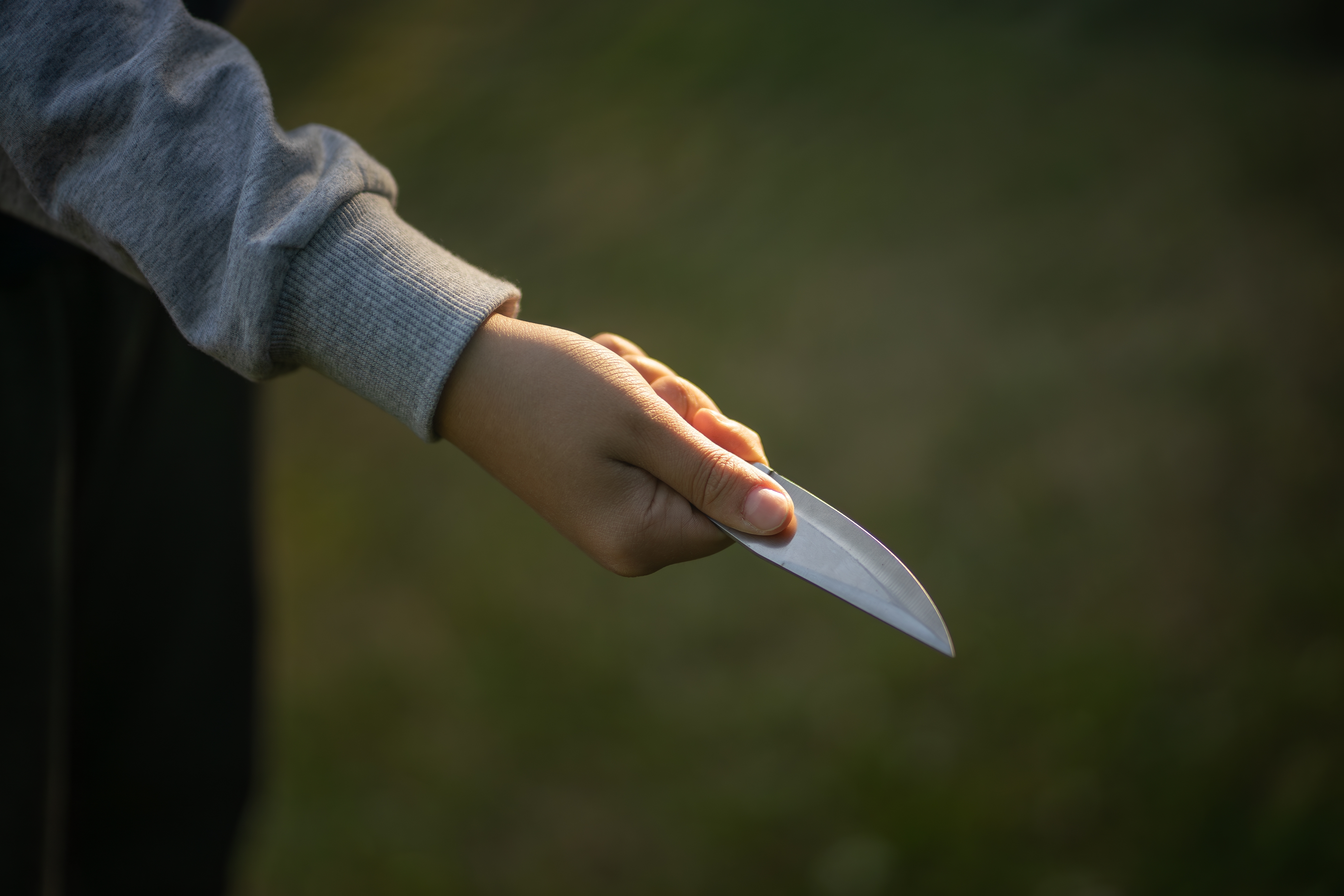 A child's hand with a sharp knife | Source: Shutterstock.com