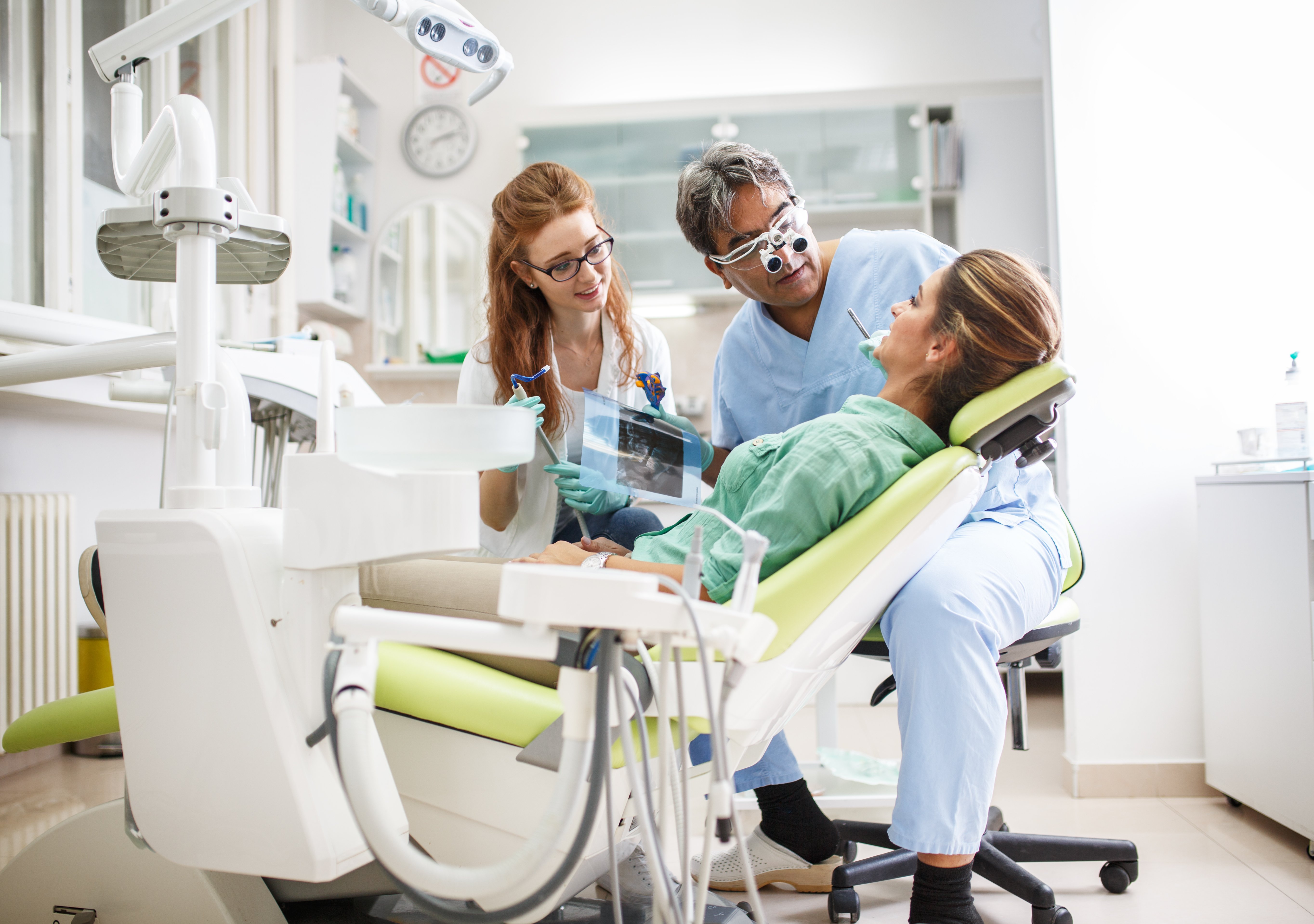 Dentist and assistant attending a patient | Photo: Shutterstock