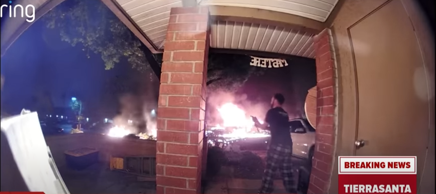 A neighbor trying to put out fire following the tragic incident posted on May 22, 2025 | Source: YouTube/@cbs8sandiego