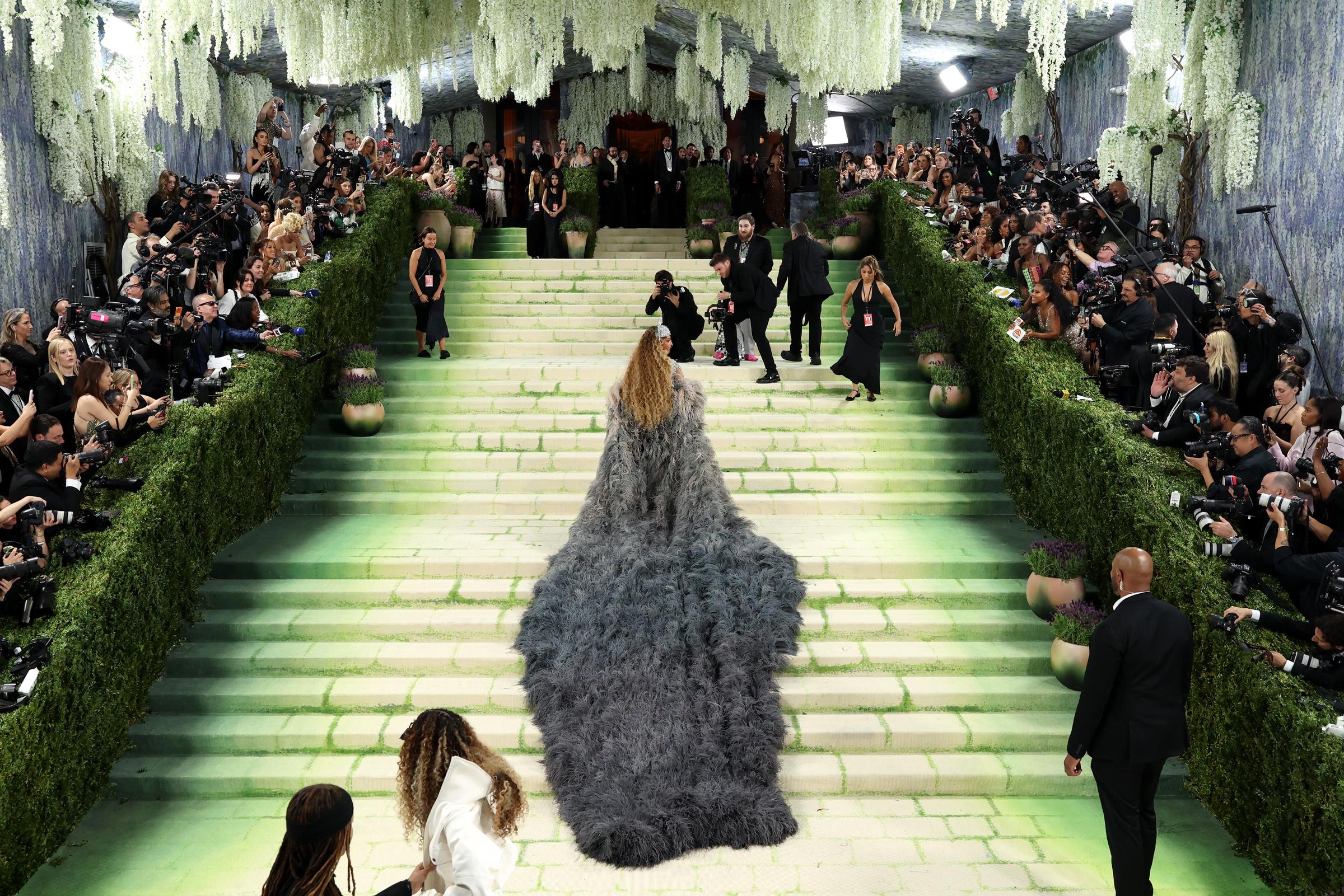 Wide view of the 2026 Met Gala staircase lined with photographers and lush greenery | Source: Getty Images