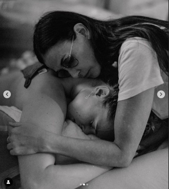 Demi Moore embraced her daughter, Rumer Willis, during her home birth, as depicted in a photo shared in May 2023. | Source: Instagram/demimoore