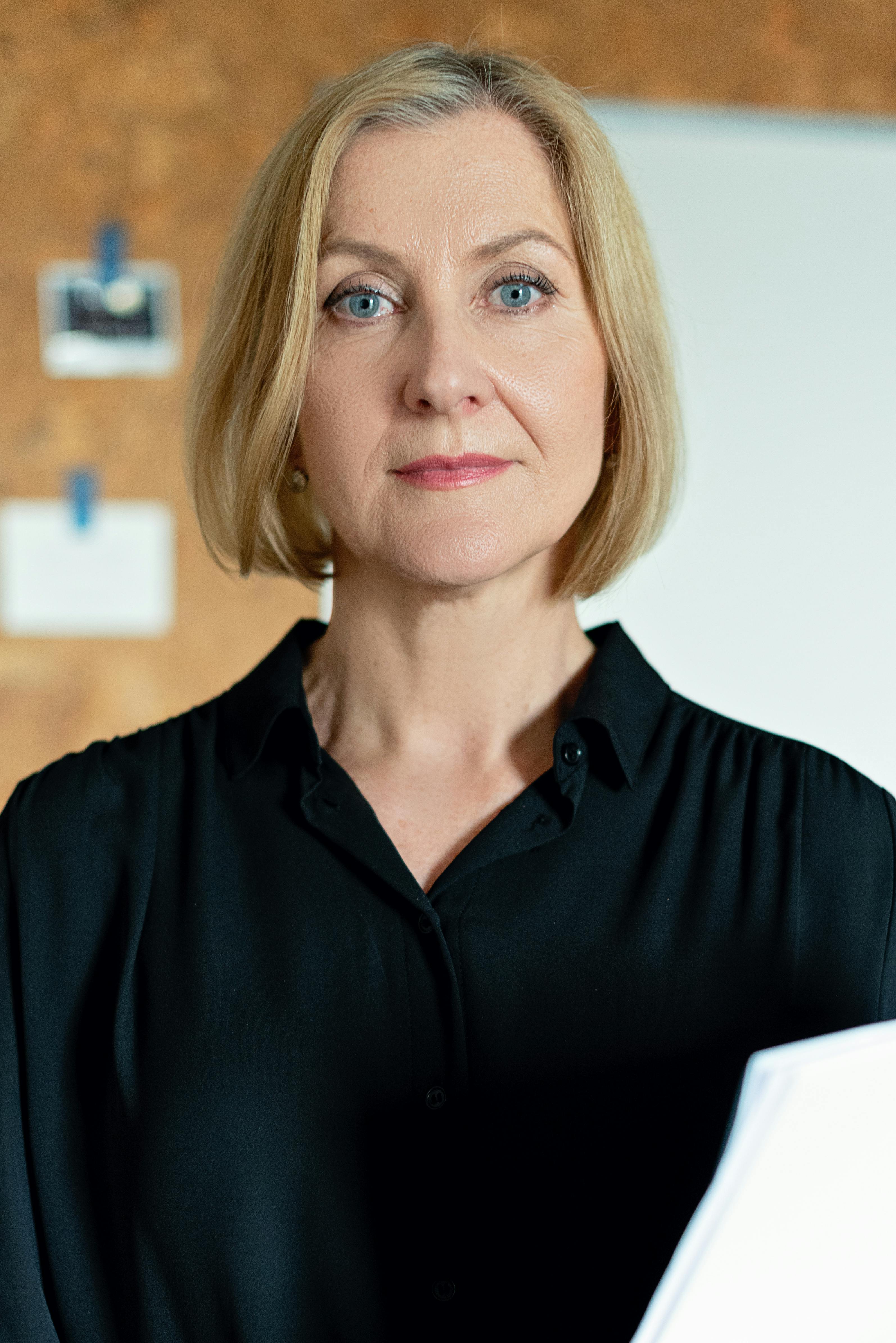 A woman holding a document | Source: Pexels