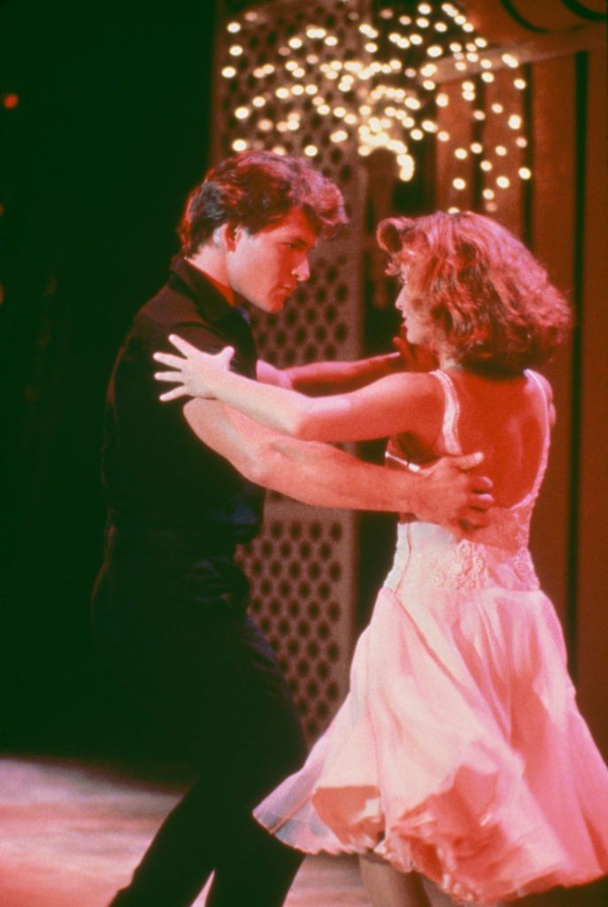 Late actor Patrick Swayze as Johnny Castle and actress Jennifer Grey as Frances "Baby" Houseman dancing during a scene from "Dirty Dancing" in 1987 | Photo: Getty Images