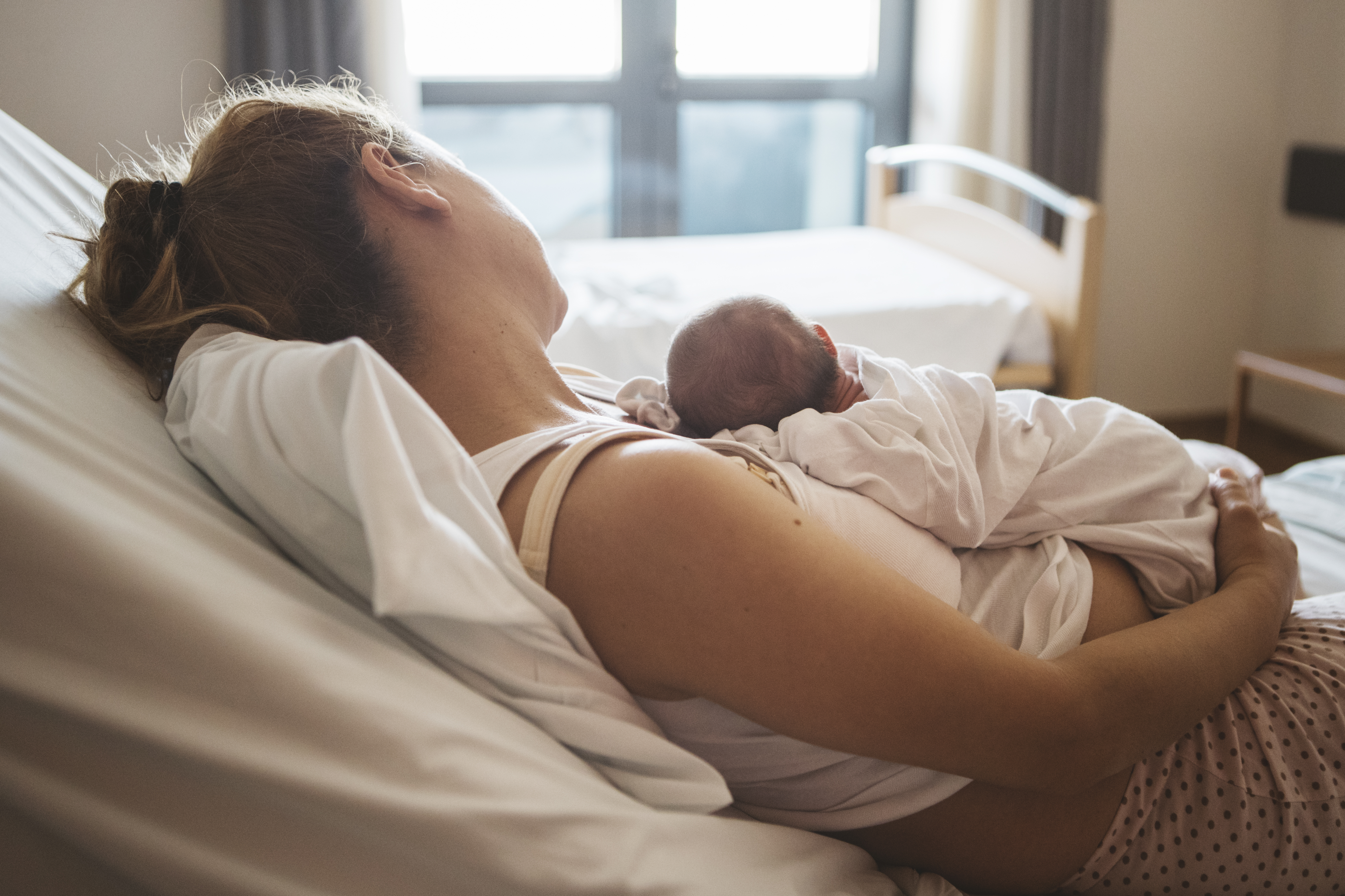 The woman holding her newborn child at a hospital | Source: Getty Images