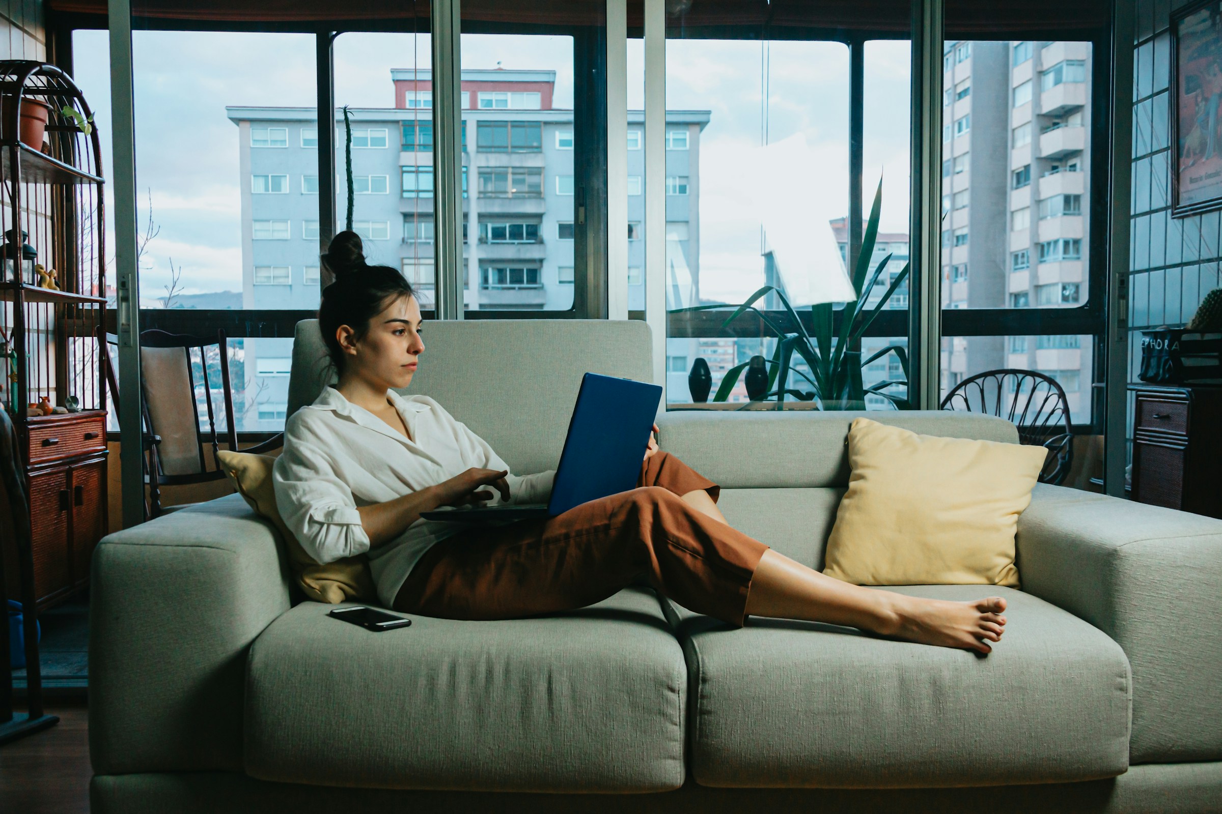 A woman lying on a sofa | Source: Unsplash