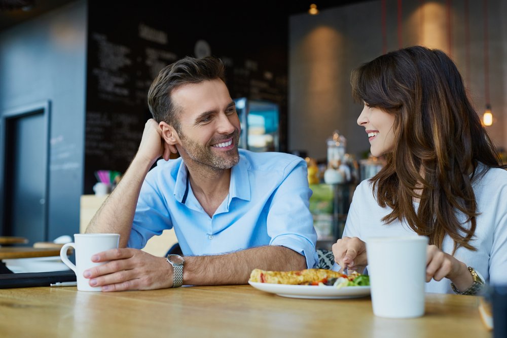 Una pareja comparte una comida entre risas. | Foto: Shutterstock