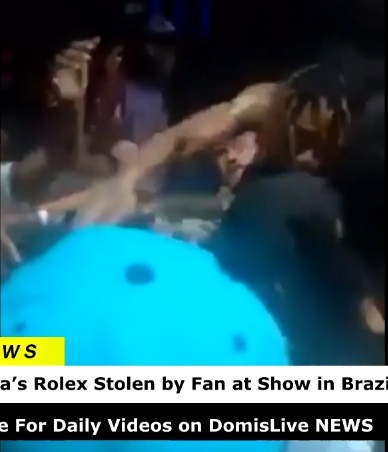 Wiz Khalifa reaches toward the crowd as confusion erupts after his watch seemingly disappears during the performance. | Source: YouTube/ DomisLive NEWS