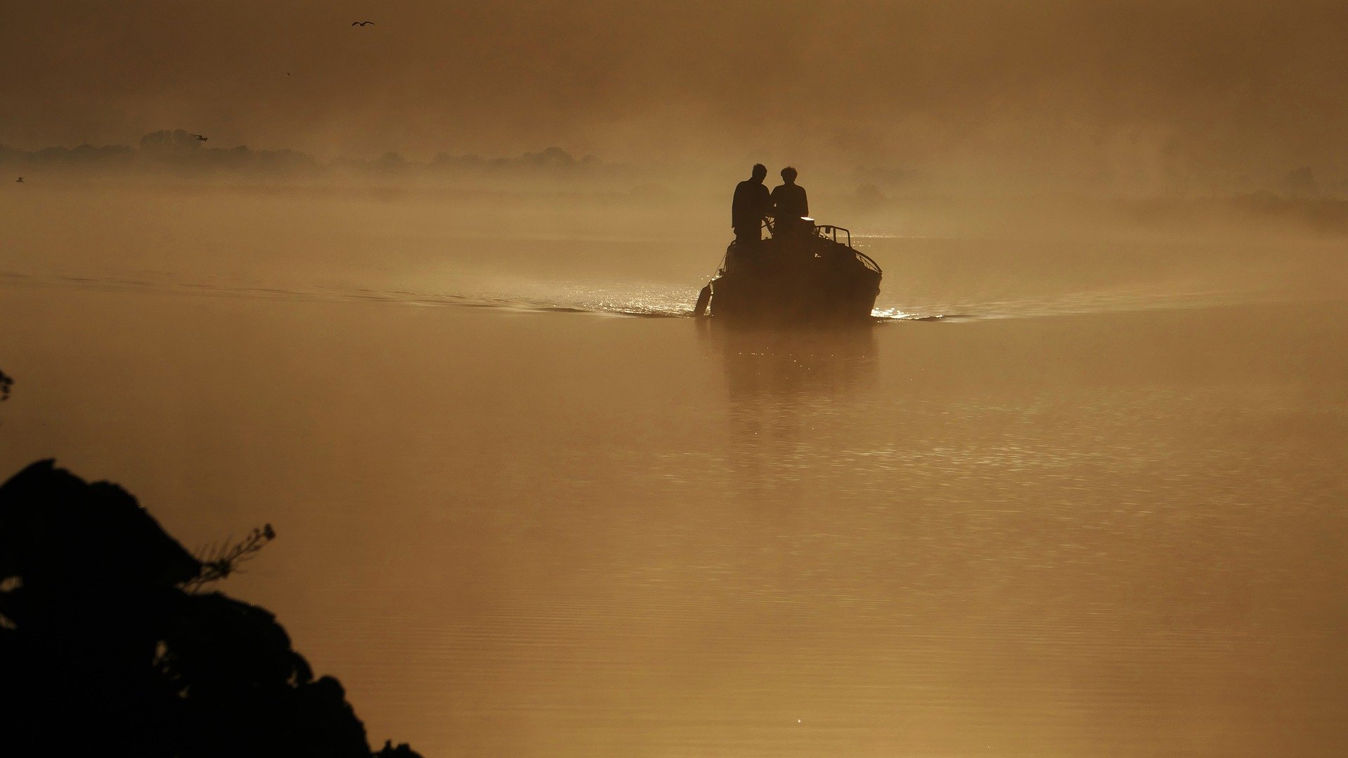 Pictured - Two individuals on a boat in the river channel | Photo: Getty Images