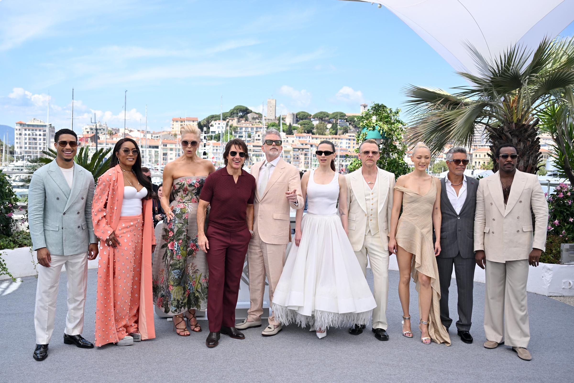 Tom Cruise stands center stage with his "Mission: Impossible – The Final Reckoning" co-stars. From left to right: Greg Tarzan Davis, Angela Bassett, Hannah Waddingham, Christopher McQuarrie, Hayley Atwell, Simon Pegg, Pom Klementieff, Esai Morales, and Tramell Tillman.