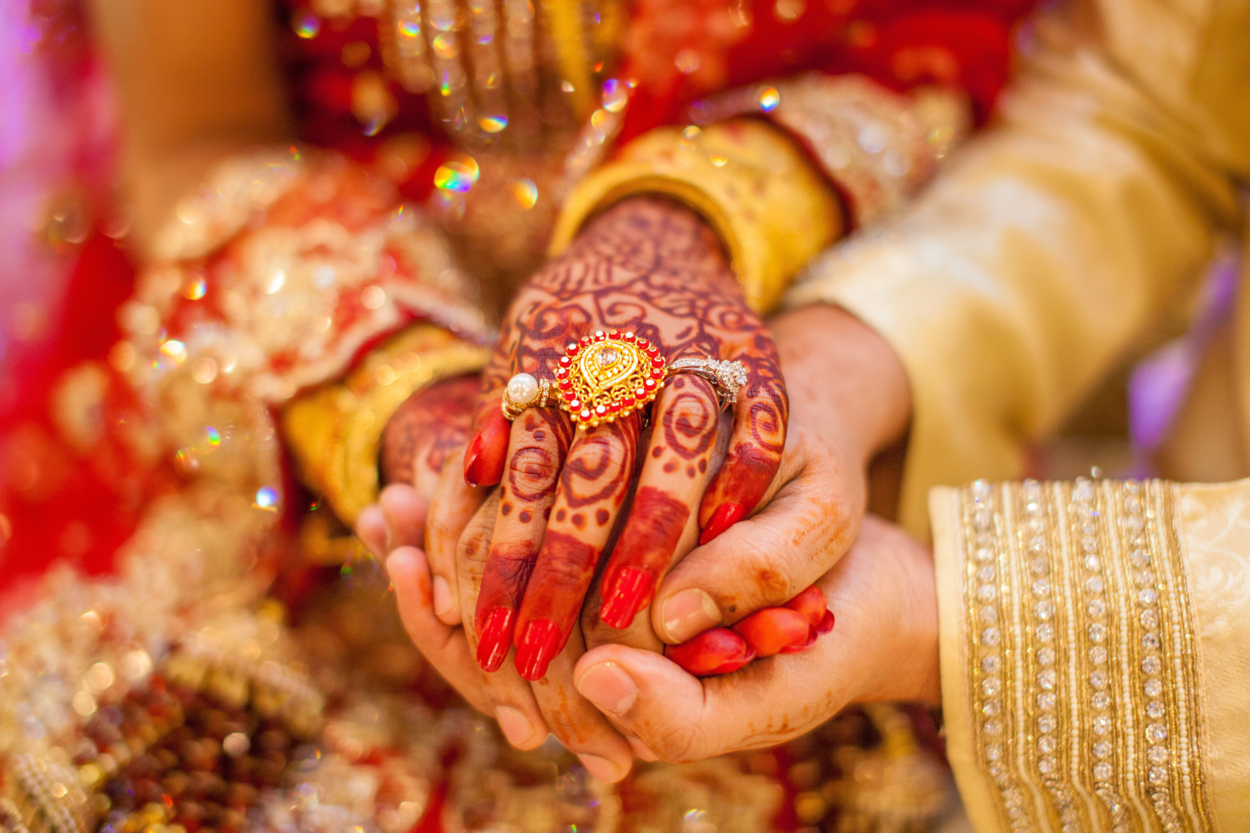 A woman hands with gold rings and henna | Source: Shutterstock
