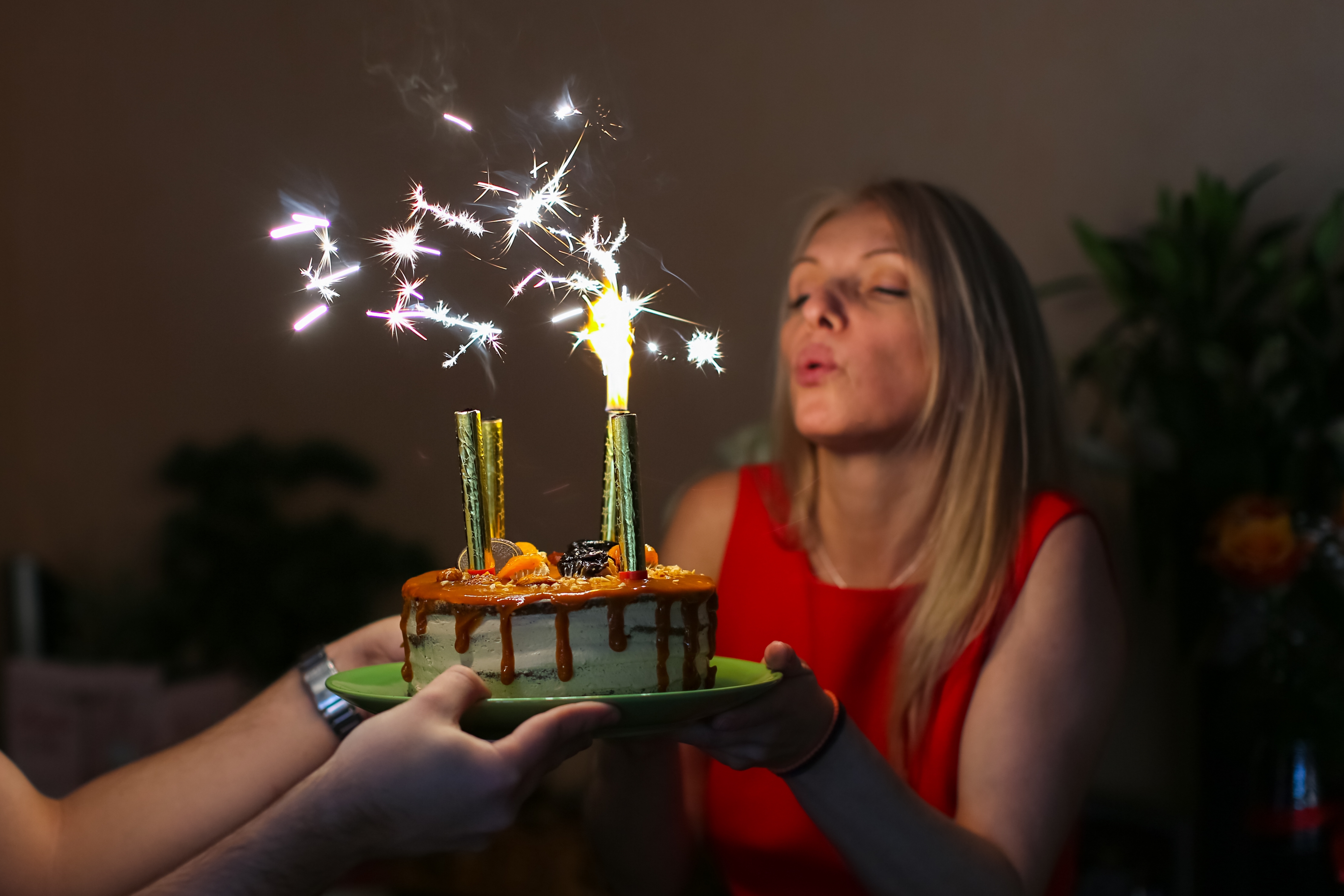 A woman holding a birthday cake | Source: Shutterstock