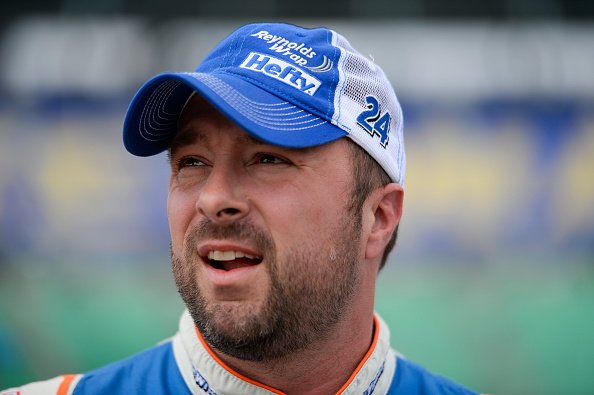 Eric McClure, driver of the #24 Reynolds Wrap Toyota, stands in the garage area during qualifying for the NASCAR XFINITY Series Kansas Lottery 300 on October 17, 2015 | Photo: Getty Images