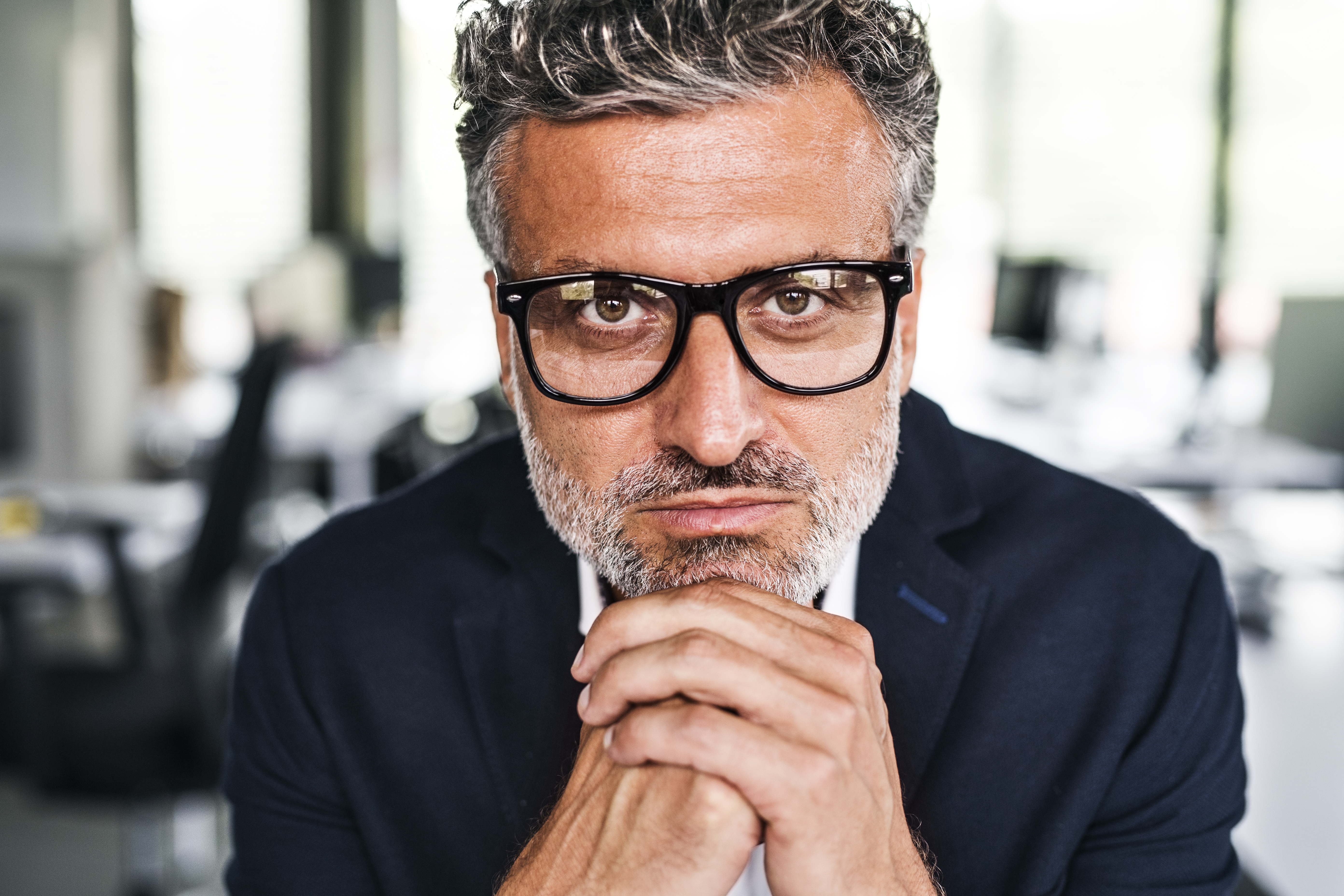 Portrait of serious mature businessman wearing glasses in office | Source: Getty Images