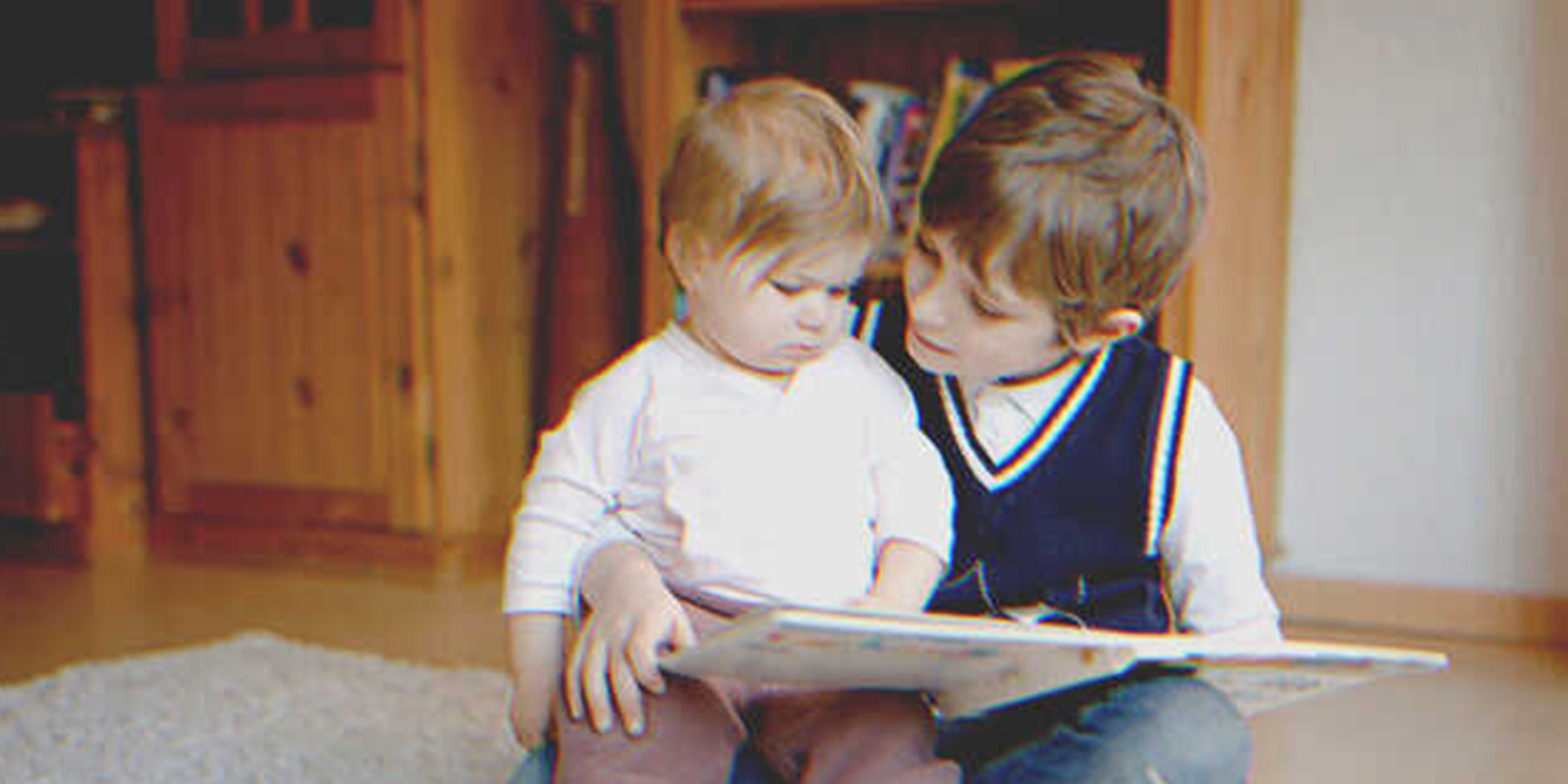 Niño lee un cuento a una bebé | Foto: Shutterstock