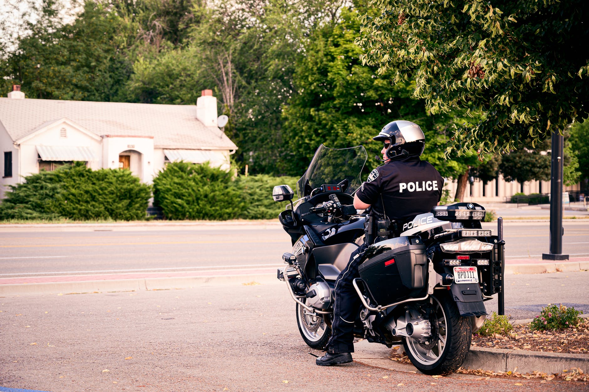 A police officer sitting on his bike during a road patrol. | Photo: Pexels
