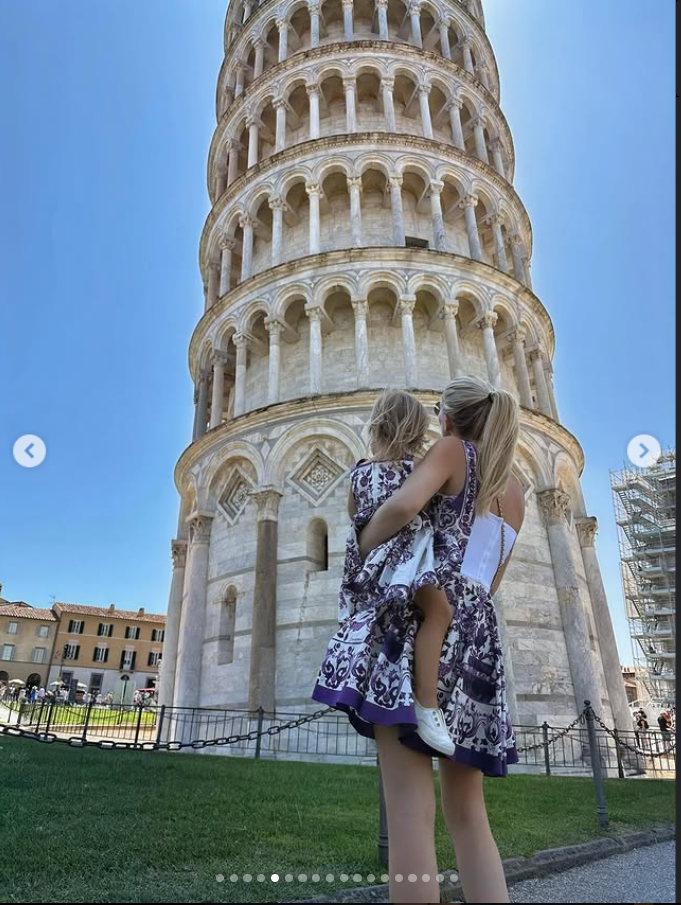 Kitty Spencer and her daughter Athena stand before the Leaning Tower of Pisa, from a post dated July 24, 2025. | Source: Instagram/kitty.spencer