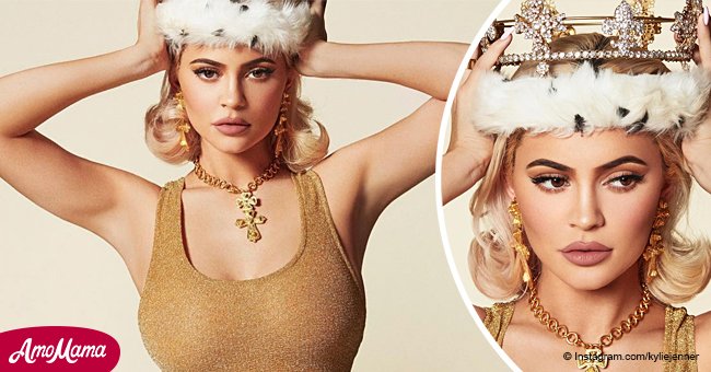 Kylie Jenner makes a bombshell queen in a crown, flaunting her curves in a gold mini-dress