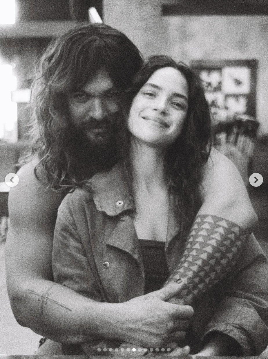 Jason Momoa hugs his girlfriend Adria Arjona in a picture dated August 1, 2025 | Source: Instagram/adriaarjona