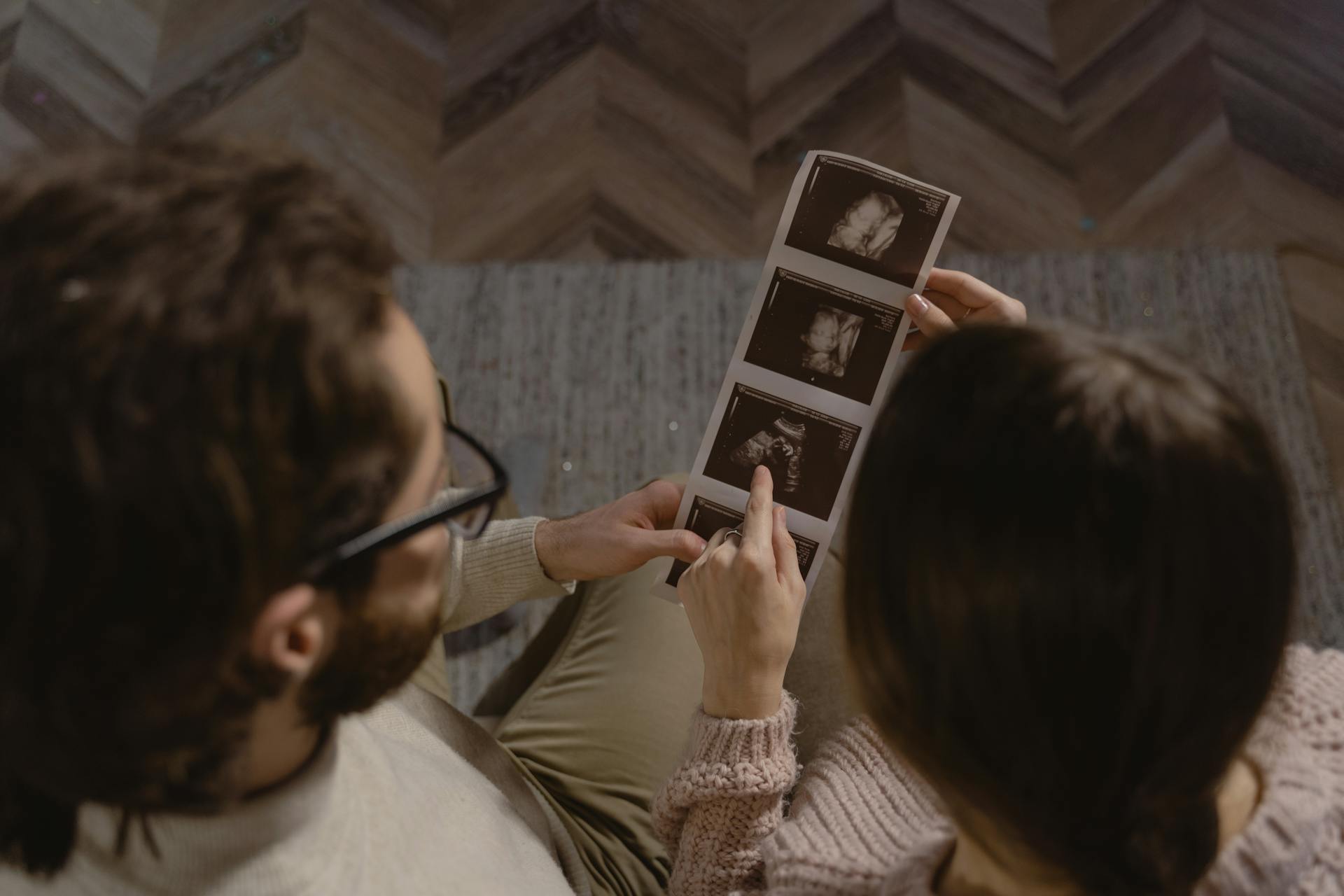A couple looking at sonogram photos | Source: Pexels
