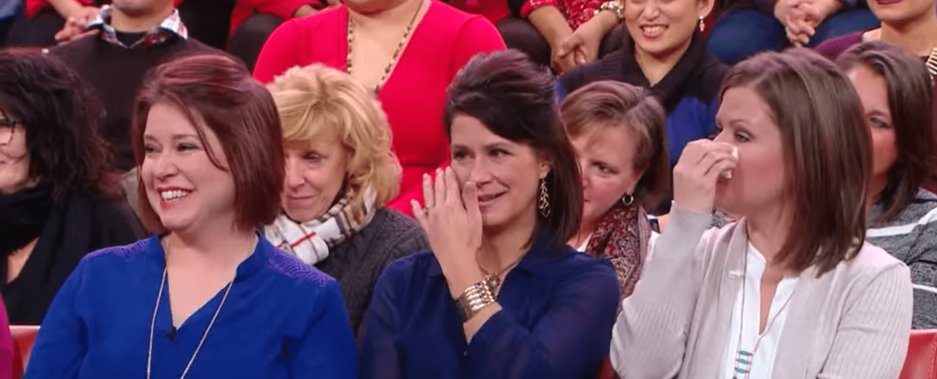 Audience member attending the "Rachael Ray" show smiling and tearing up. │Source: youtube.com/Rachael Ray Show