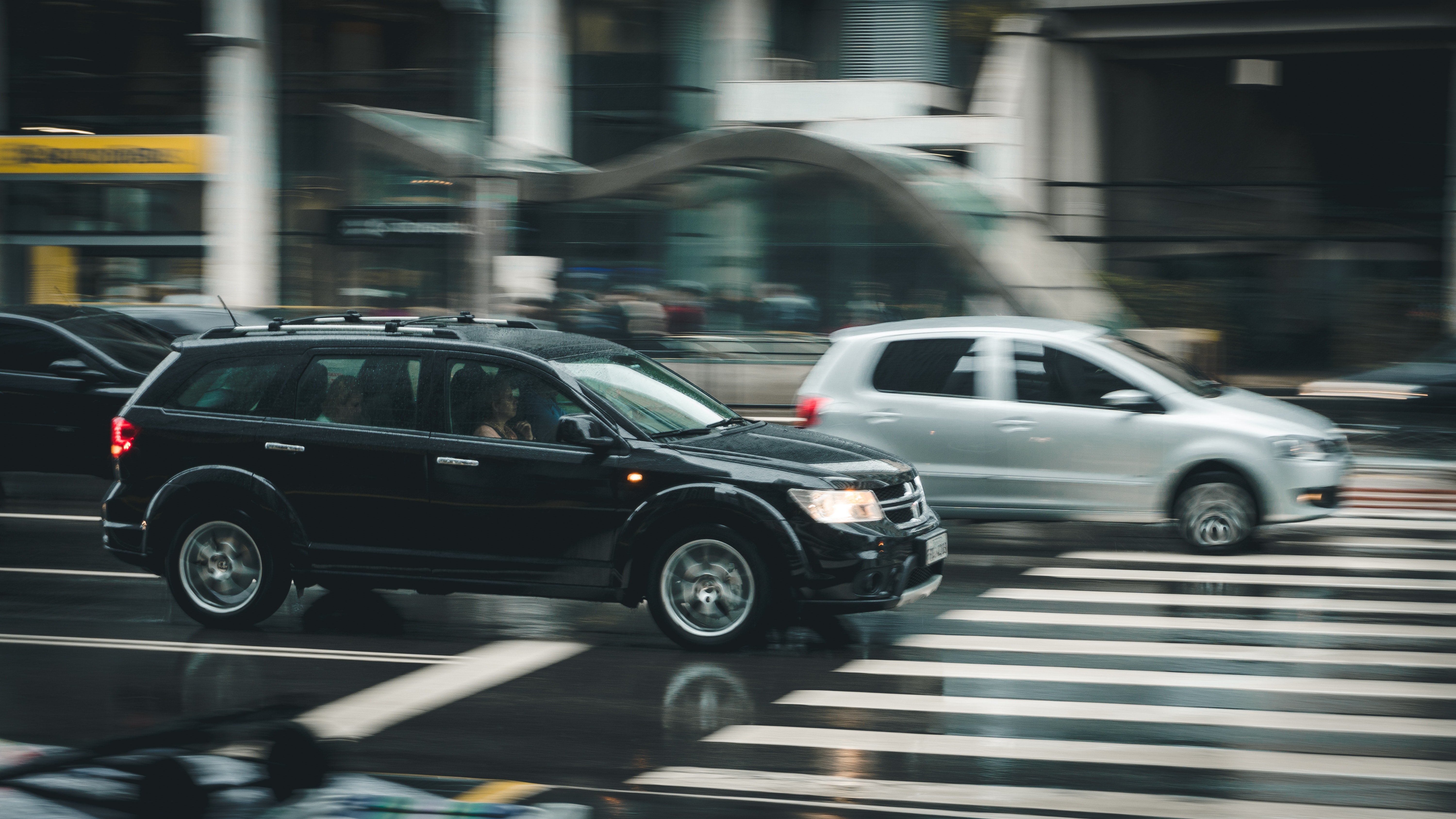 Two cars driving over a zebra stripe. | Source: Pexels/Kaique Rocha