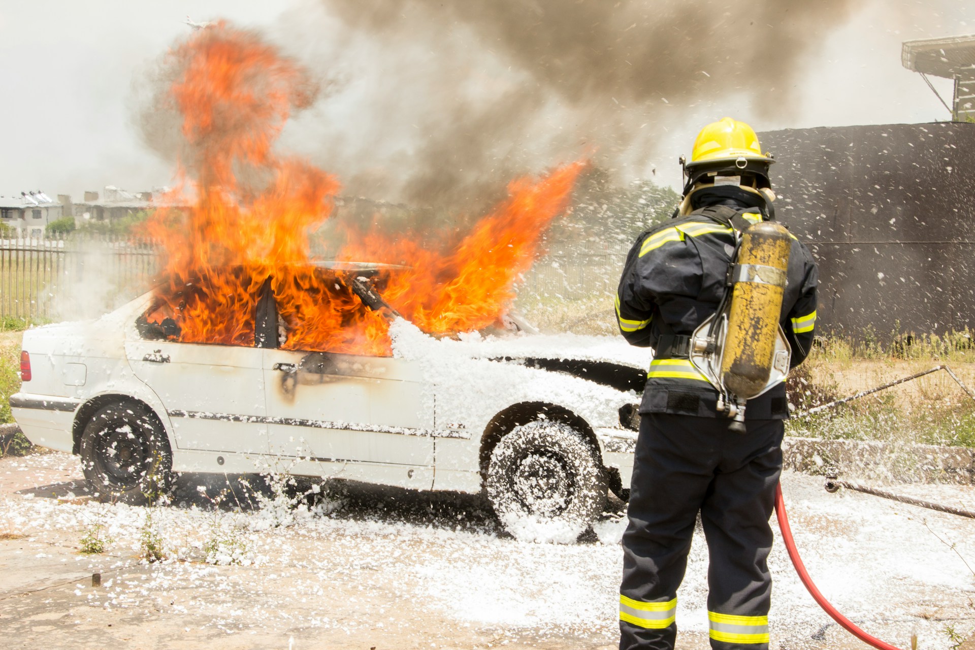 A firefighter standing near a burning car | Source: Unsplash