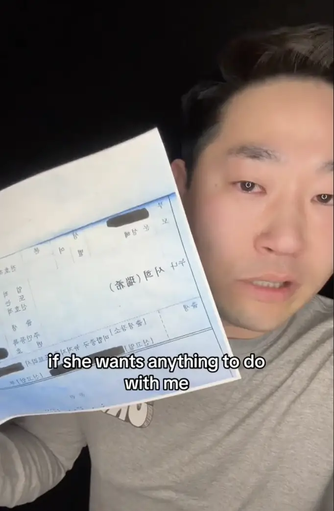 Ed Choi showing the only document he has on his older half-sister, as seen in a video dated November 10, 2023 | Source: TikTok/etchaskej