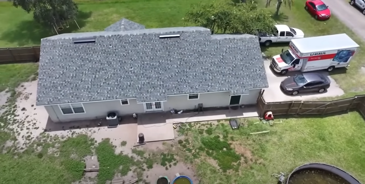 A bird's eye view of the house with the U-Haul van parked outside the house, from a video post dated August 2, 2025 | Source: YouTube/FirstCoastNews