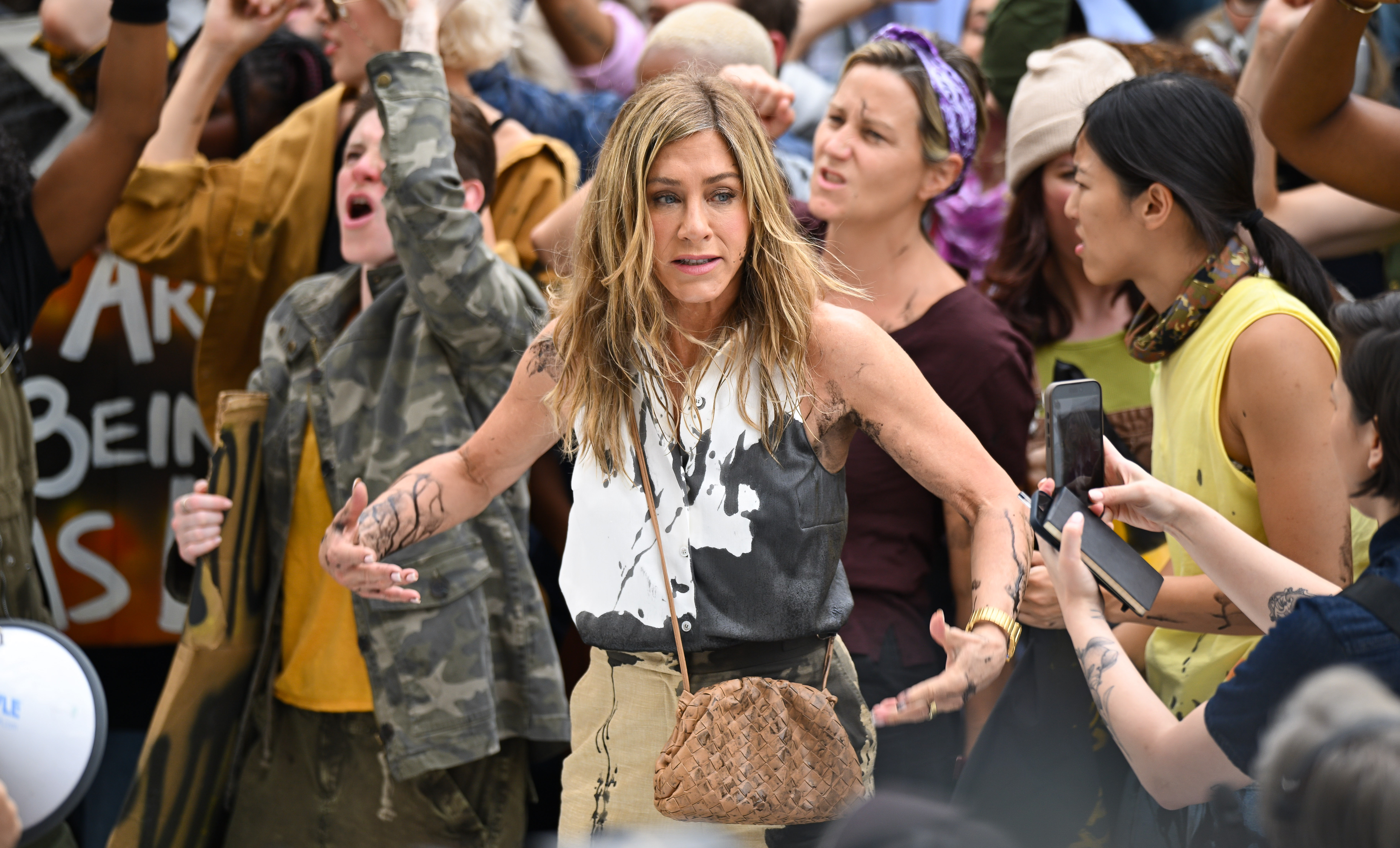 Jennifer Aniston reacts as black oil splashes on her in the Flatiron District of New York City on July 28, 2024 | Source: Getty Images