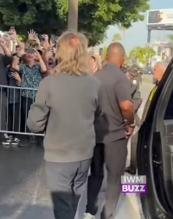 From behind, Paul McCartney was seen approaching a line of eager fans, his longer hair brushing the collar of his jacket as he moved towards the crowd. The scene captured the scale of the reception, with hands raised and phones outstretched, highlighting the enduring excitement that follows him wherever he goes. | Source: Facebook/IWMBuzz