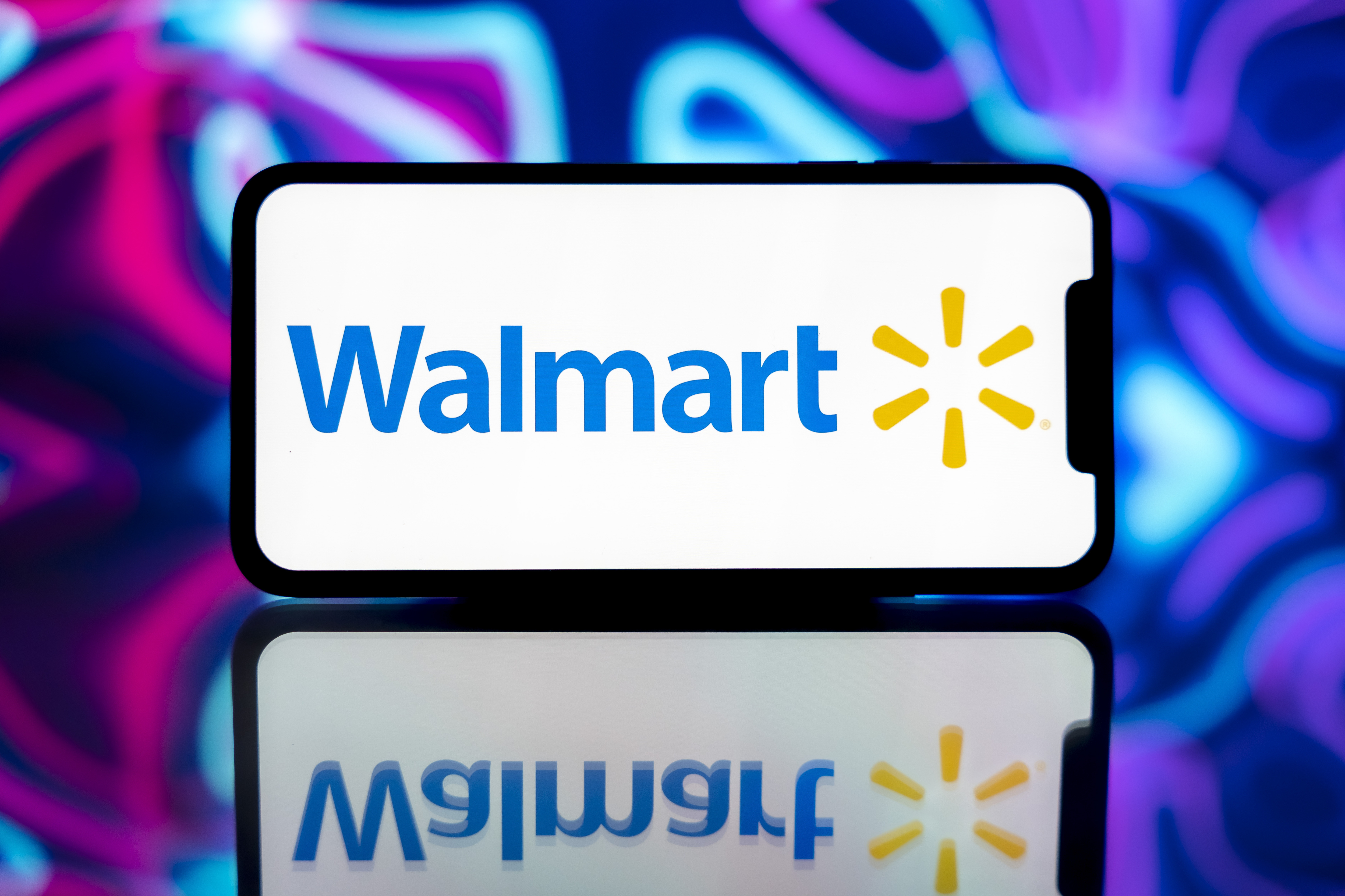 A smartphone displaying the Walmart logo in India on December 14, 2024. | Source: Getty Images