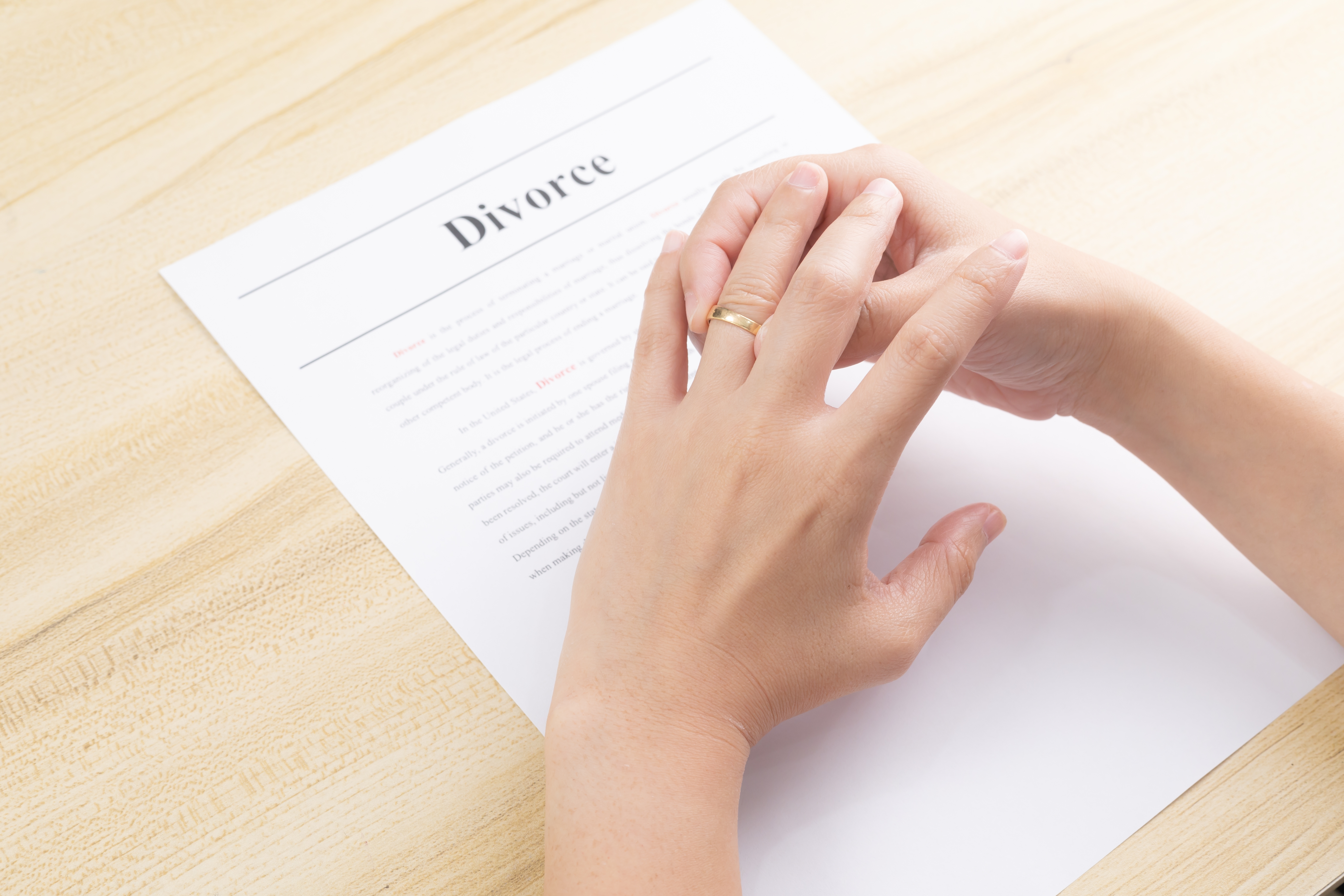 A woman's hand over divorce papers | Source: Shutterstock