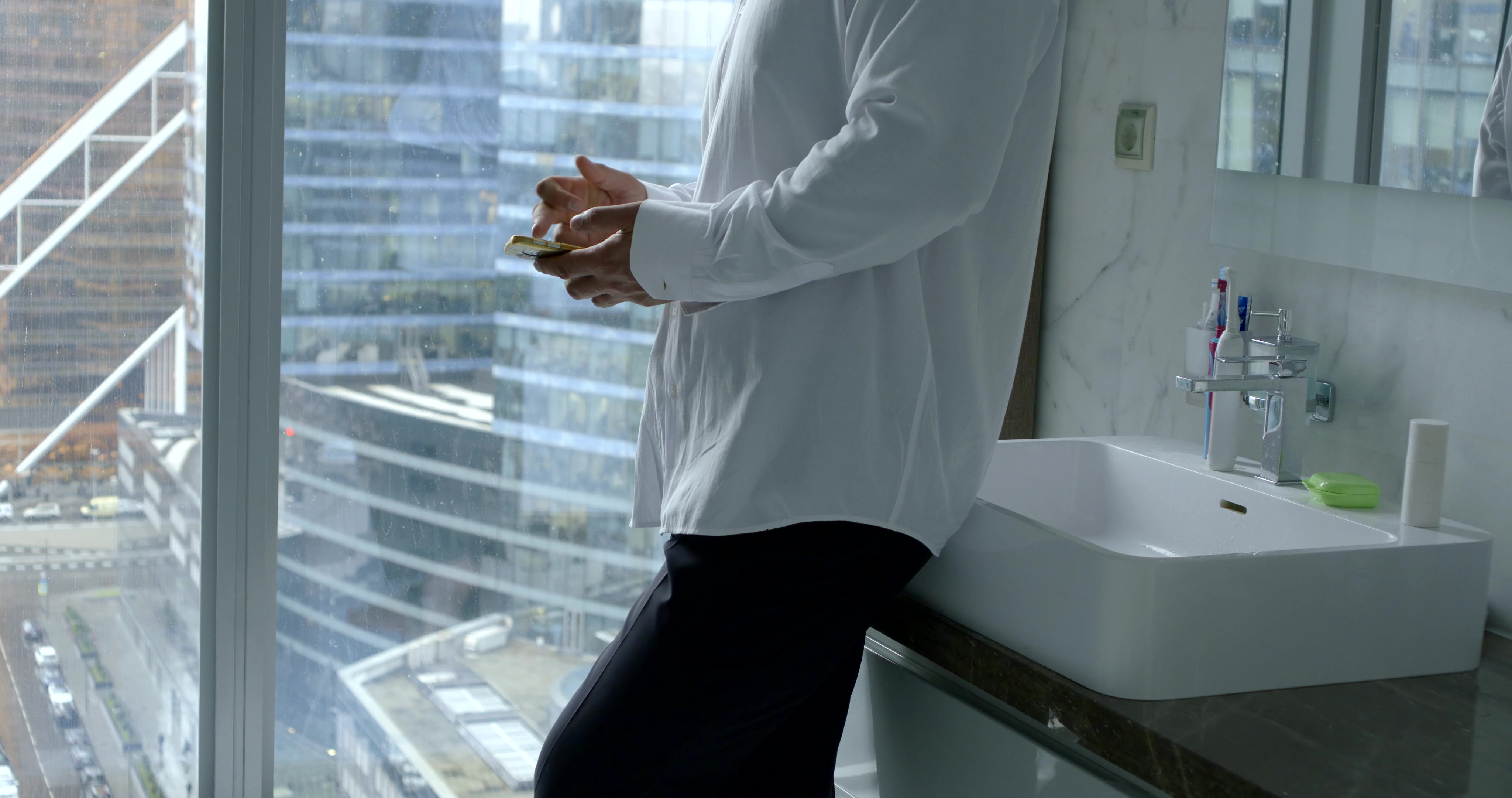 Man with smartphone in toilet. | Source: Shutterstock