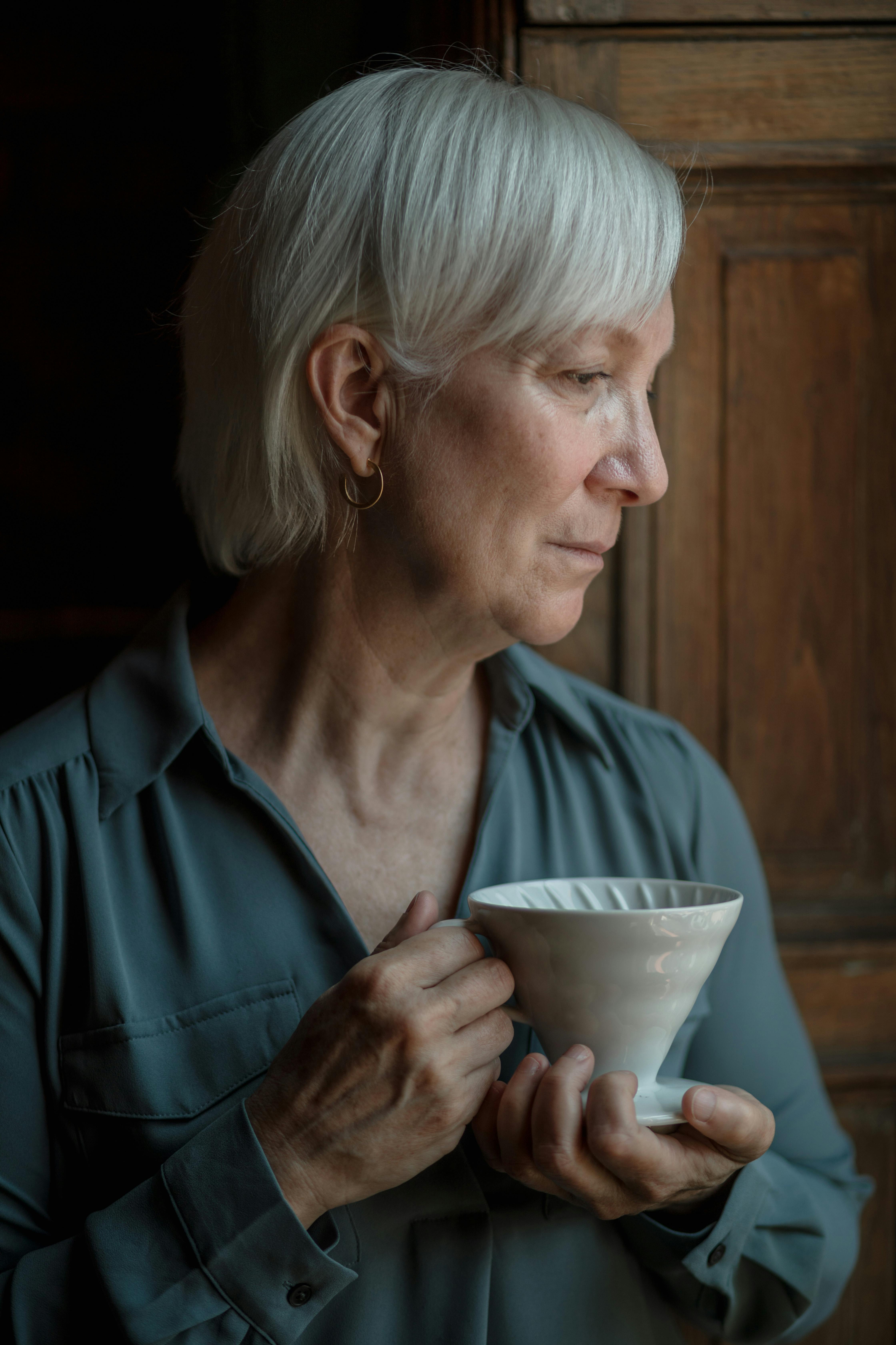 A serious woman standing by an open door | Source: Pexels