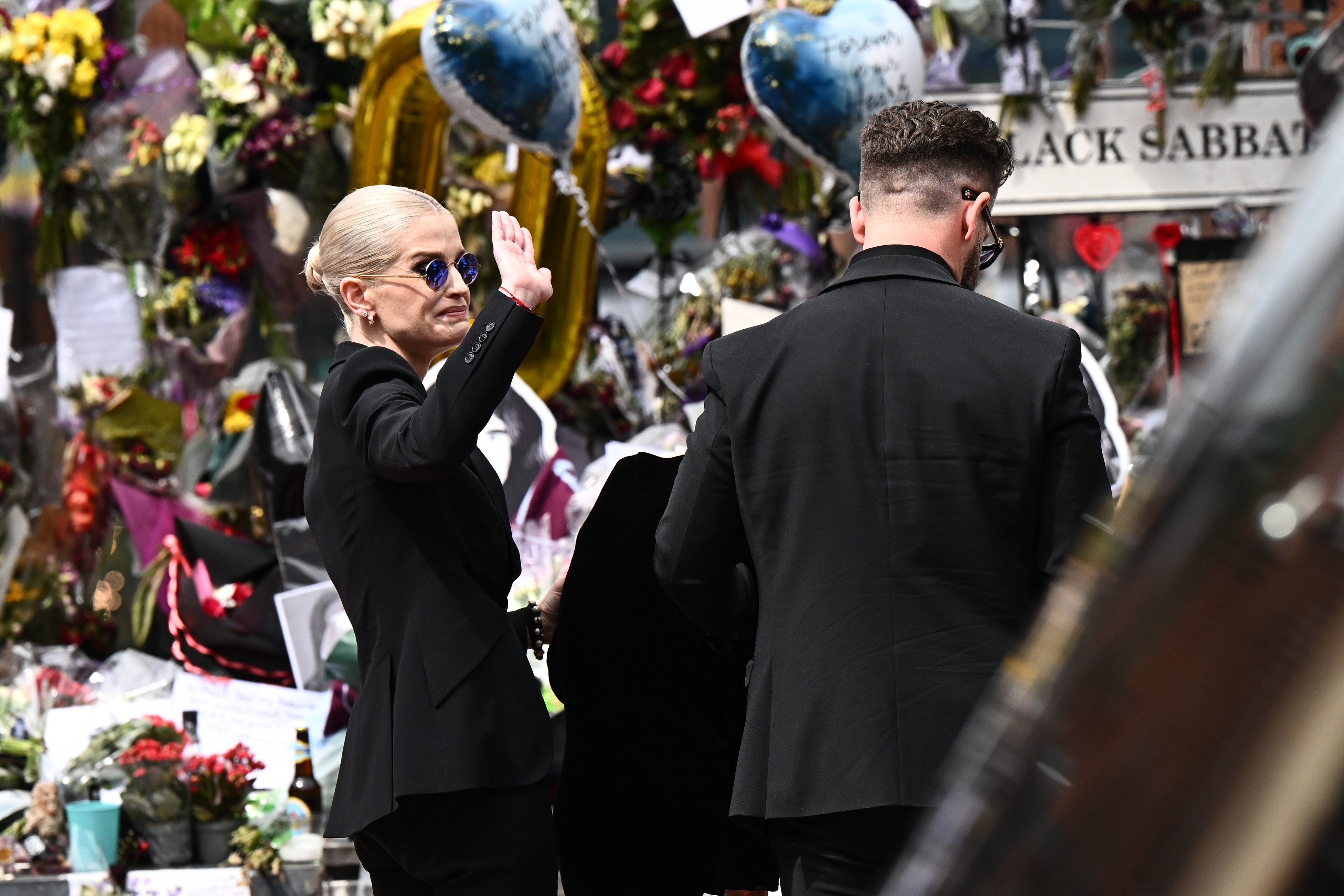 Kelly Osbourne waves at fans as Sharon and Jack pay their respects to Ozzy in Birmingham, England on July 30, 2025. | Source: Getty Images