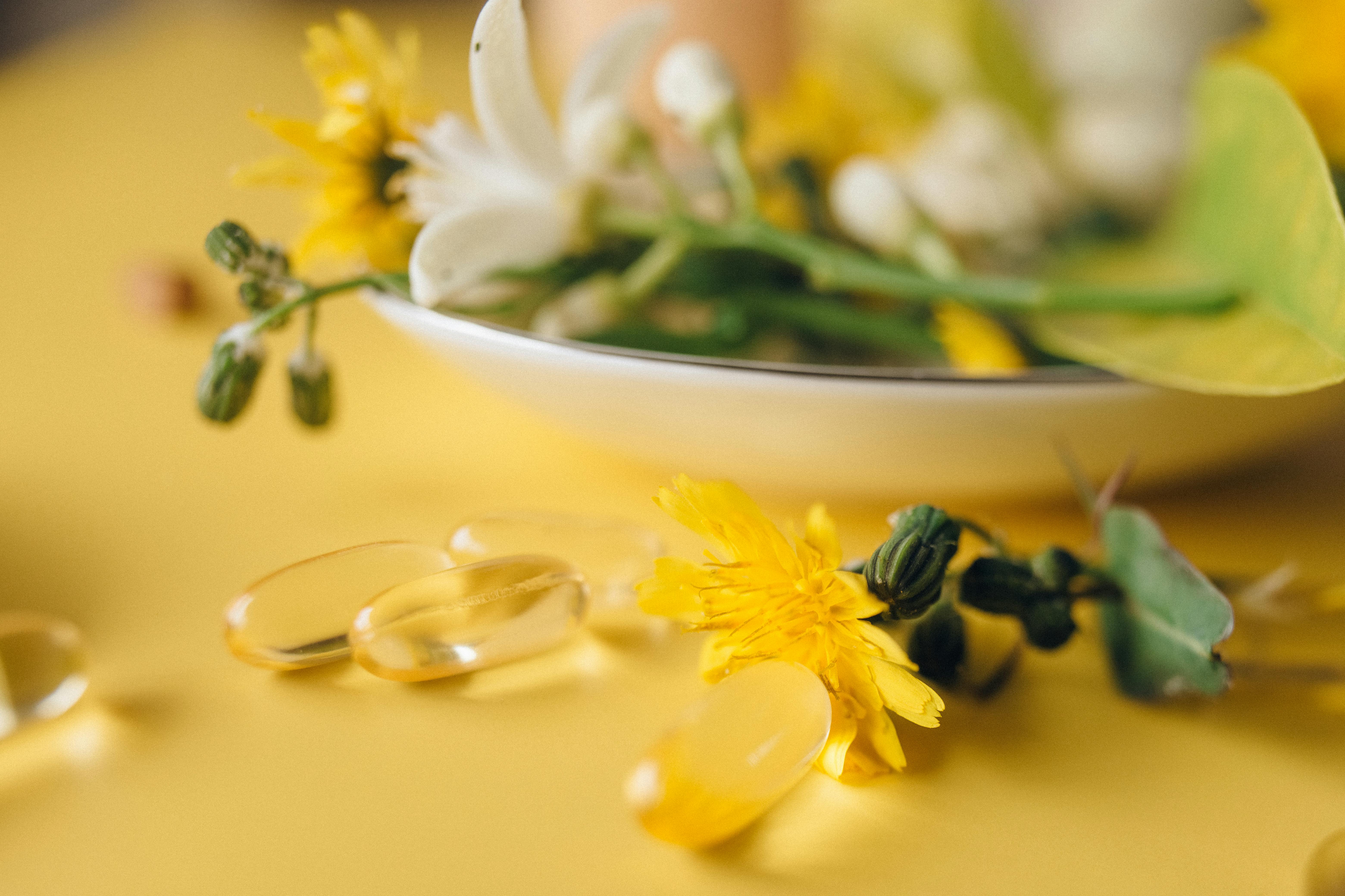 Vitamin tablets on a yellow background | Source: Pexels