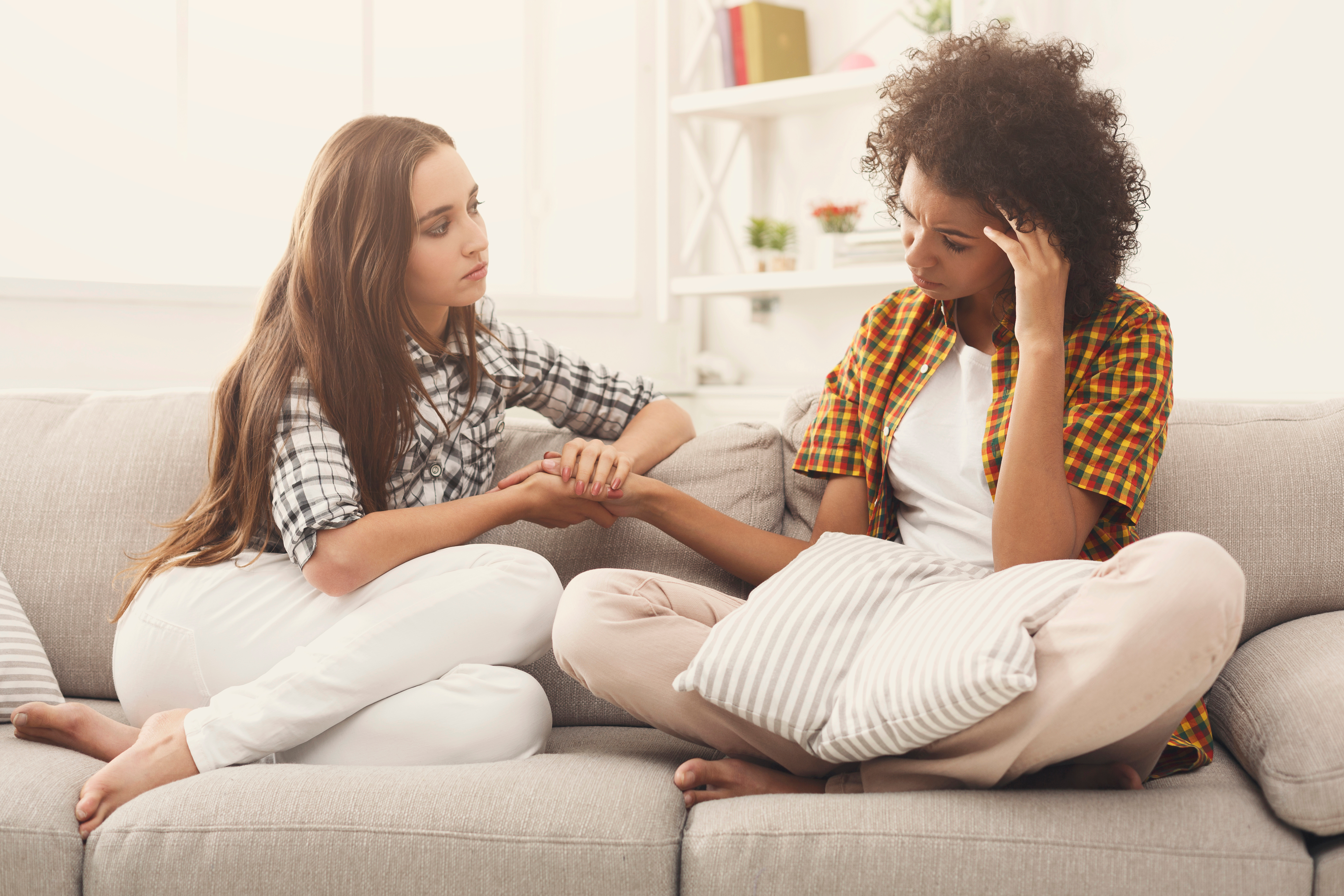 Two women are pictured talking and comforting each other | Source: Shutterstock