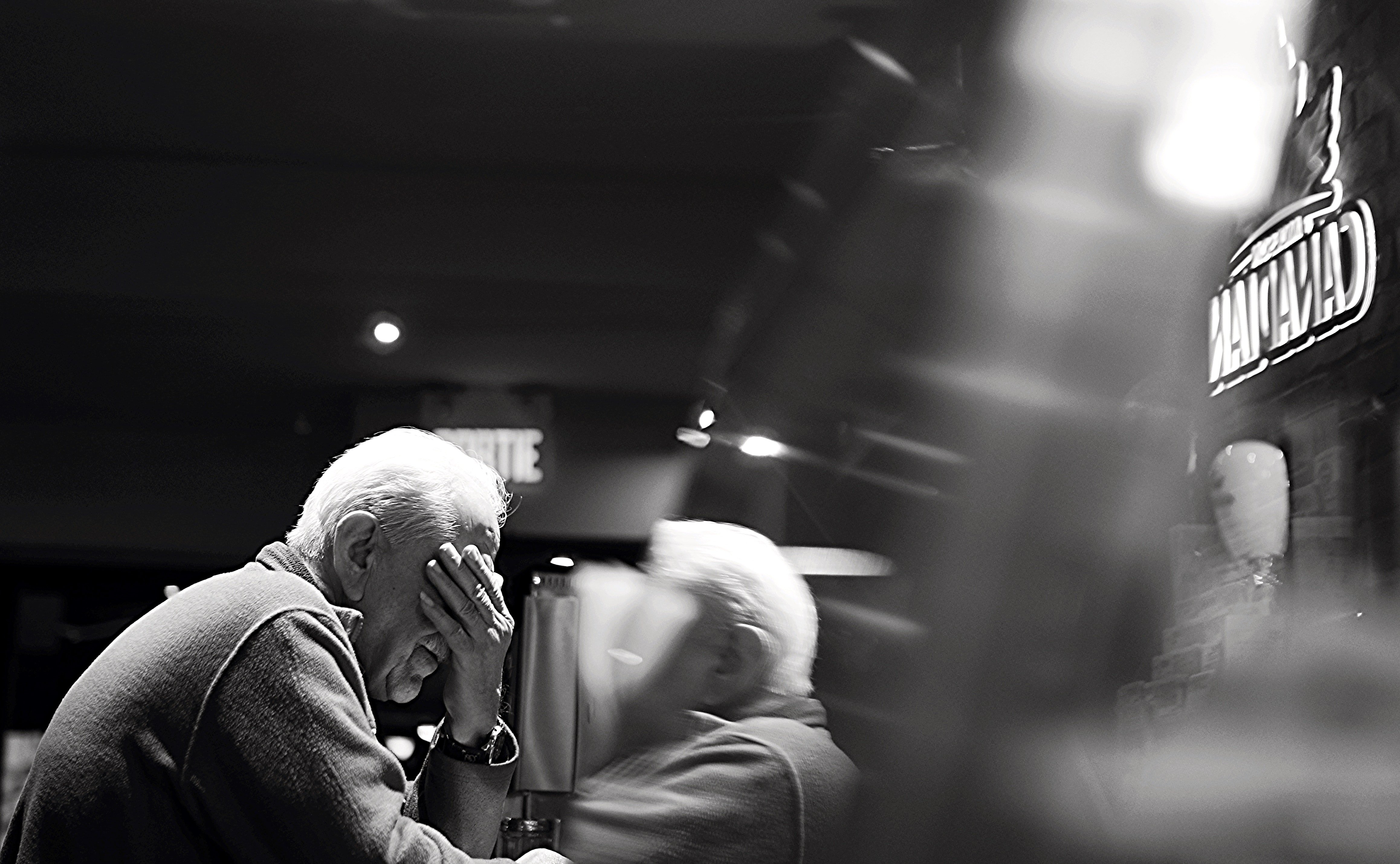 An elderly man sitting in a bar | Photo: Pexels
