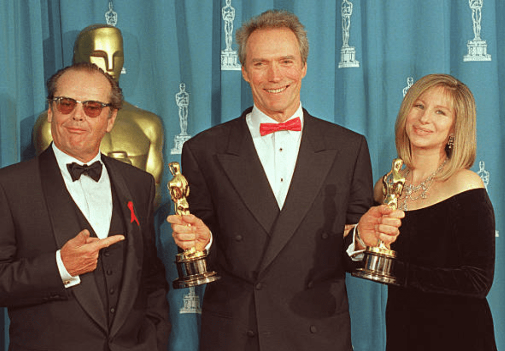 Clint Eastwood holding his two Oscars at the 65th Annual Academy Awards in 1993 with Jack Nicholson and Barbra Streisand | Photo: Scott Flynn/AFP via Getty Images