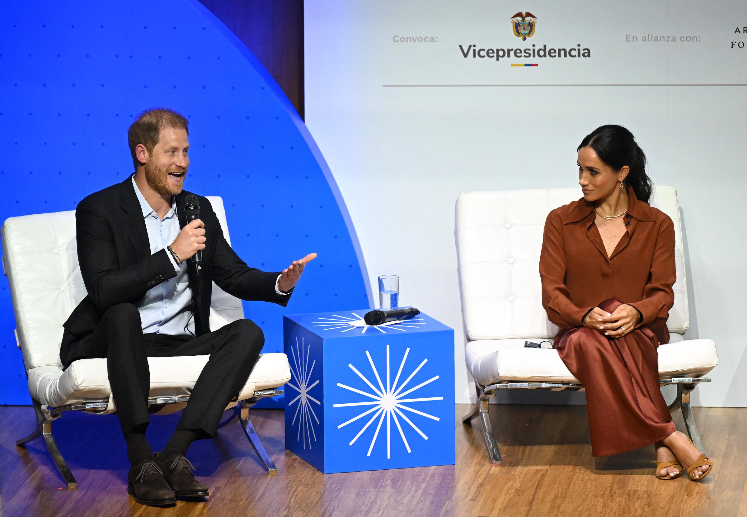 Prince Harry speaking during the "Responsible Digital Future" forum as his wife Meghan Markle listens in Bogota on August 15, 2024 | Source: Getty Images