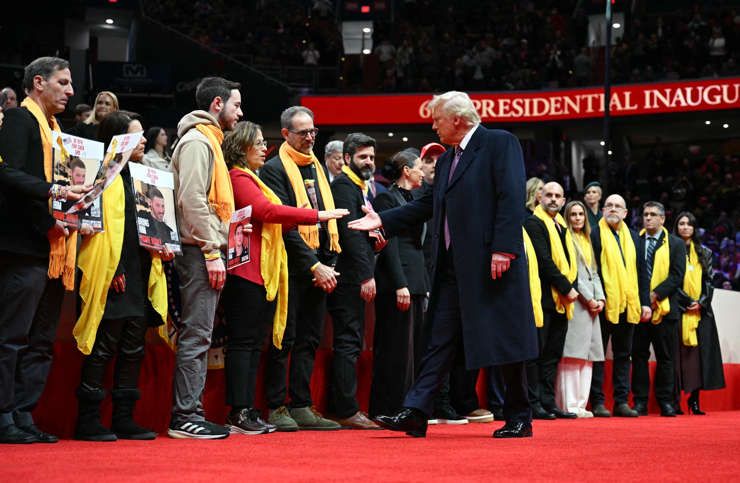 Donald Trump shakes hands with relatives of Israeli hostages of Hamas during the inaugural parade inside Capital One Arena, in Washington, DC, on January 20, 2025 | Source: Getty Images