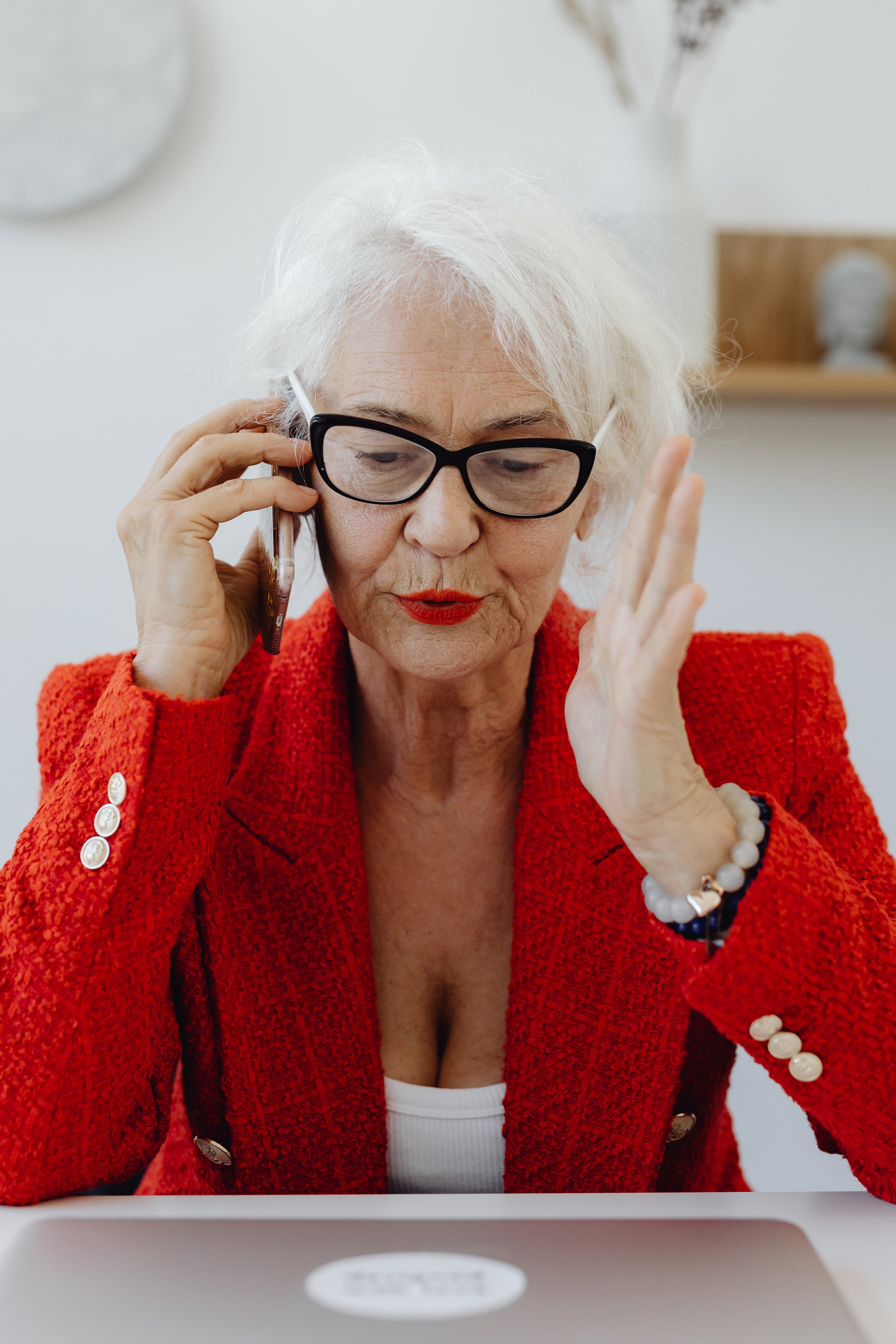 An older woman talking on the phone | Source: Pexels