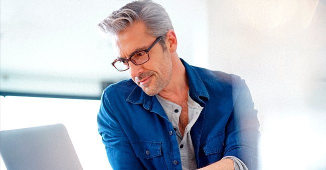 A man staring amusingly at his computer | Photo: Shutterstock.com