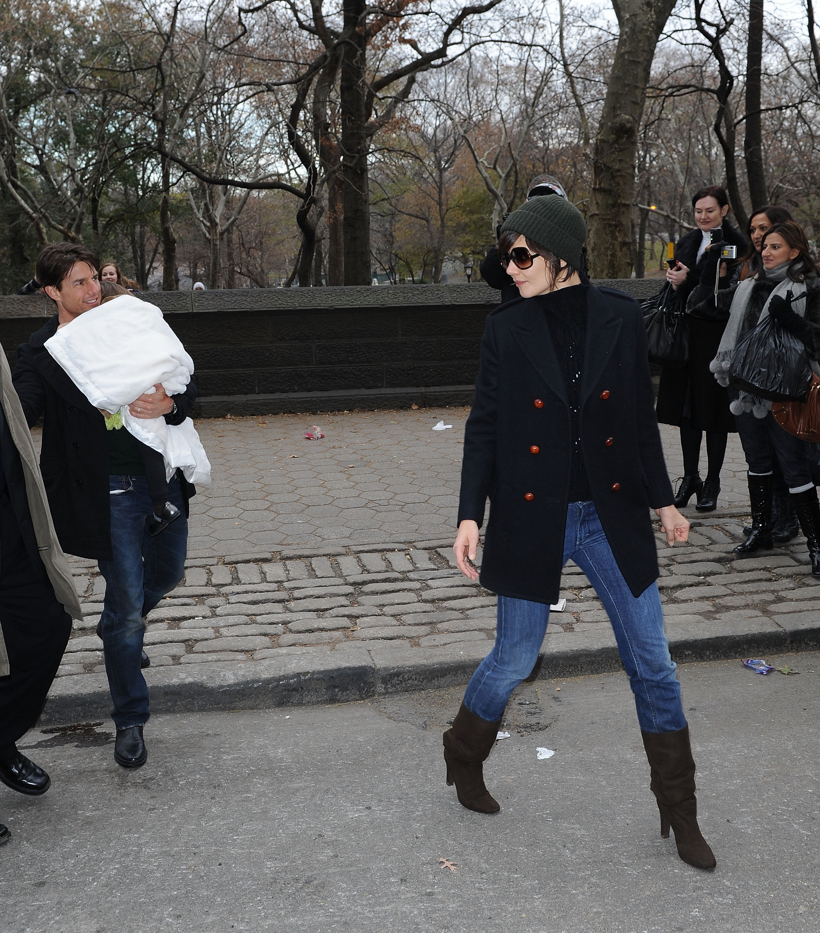 Tom Cruise carries baby Suri while Katie Holmes walks beside them during an outing in New York shortly after Suri's birth, when the family was among Hollywood's most closely watched. | Source: Getty Images