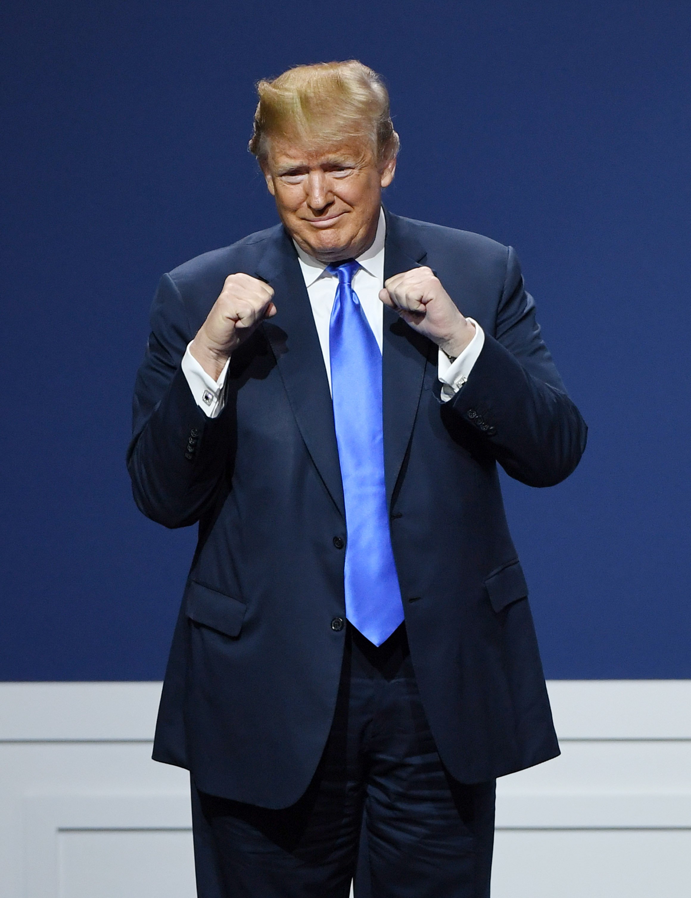 Donald Trump pumps his fists on stage during the Republican Jewish Coalition's annual leadership meeting at The Venetian Las Vegas on April 6, 2019 | Photo: GettyImages