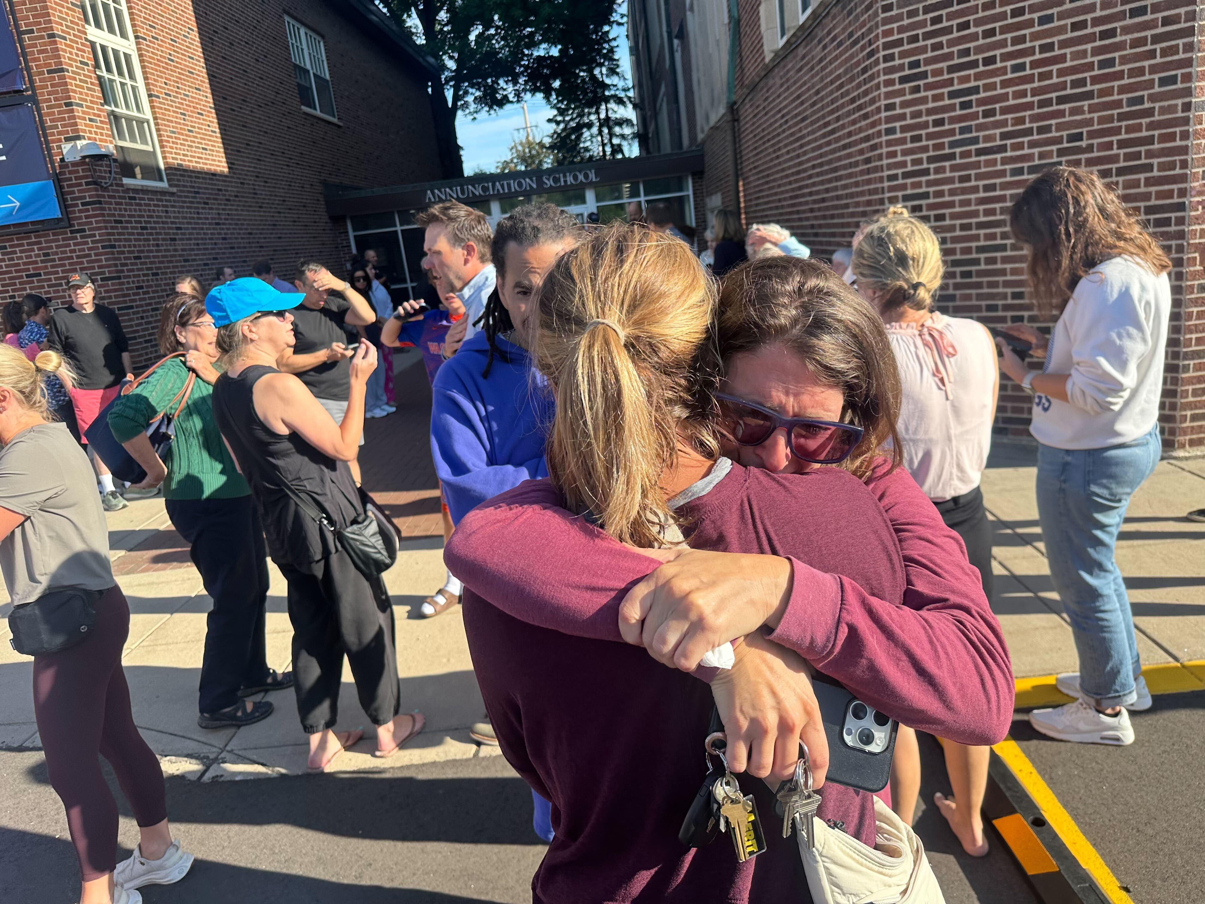 Parents outside Annunciation School following the mass shooting on August 27, 2025, in Minneapolis, Minnesota. | Source: Getty Images